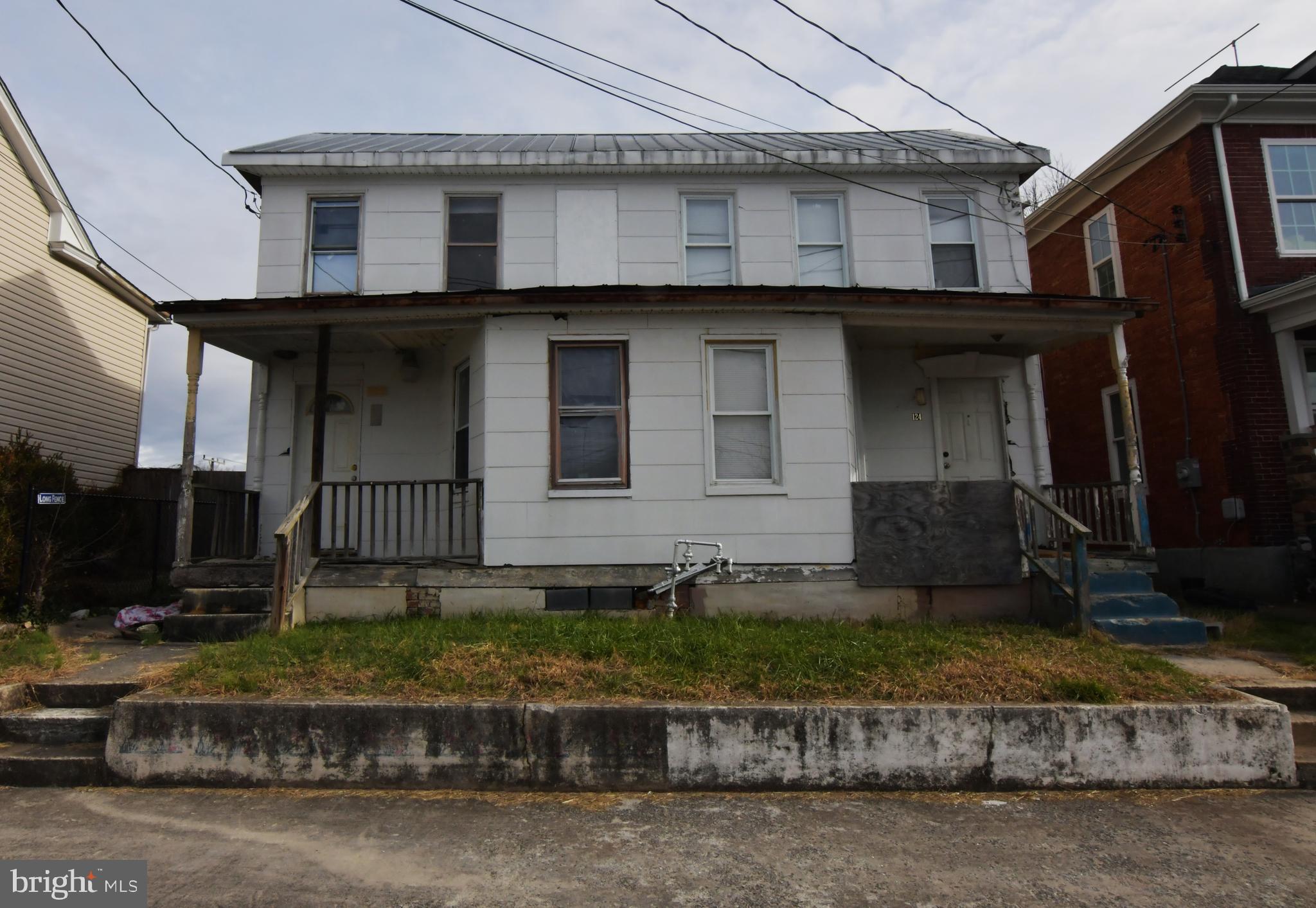 OWN A DUPLEX -  GET TWO UNITS FOR THE PRICE OF ONE! GREAT OPPORTUNITY IN DOWNTOWN MARTINSBURG. EXCELLENT RENOVATION PROJECT FOR LANDLORDS,  FLIPPERS AND OTHERS WHO ARE WILLING TO ROLL UP THEIR SLEEVES AND GET TO WORK.  Sold strictly as-is, where-is. Cash only. Each side has 3 bedrooms and one bath. Deep back yard. This is one of six residential properties with houses in various stages of interior demo/reno that are being offered for sale by this owner. Six building lots also are for sale. The Eastern Panhandle is one of the fastest growing areas of West Virginia. Residents of Martinsburg and Berkeley County are attracted to the small-town atmosphere, employment opportunities, restaurants, shopping, services, medical facilities, a revitalizing downtown, and access to major roads I-81, Rt. 9 and Rt. 11, the MARC train and Amtrack. Lot sizes are approximate. Buyer to verify natural gas availability. Cash only - proof of funds required.