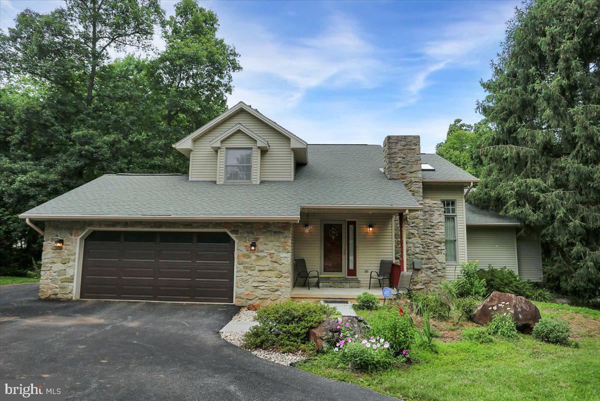 You don't want to miss one!  
This well-maintained home sits on 6.39 acres of woods, yet it is just off Rt 15 making an easy commute to Harrisburg, Gettysburg, or York!   The kitchen has high end appliances including multiple ovens and plenty of cabinet space for all your accessories!  A stunning stone fireplace with mantel is the highlight in the living room.    The main floor also includes the dining room with hardwood floors, a large primary suite, and 4 season room which is the perfect spot to watch nature in your own backyard all year long!  The laundry area is conveniently located just off the kitchen.  

The second level has 2 bedrooms a full bath plus a bonus room.

The lower level adds space with a walk out family room and storage galore.  

The large 2nd garage is 26x32 and features multiple office spaces and it's own 1/2 bath!    It has a separate electric meter making it perfect for your in-home business/office!