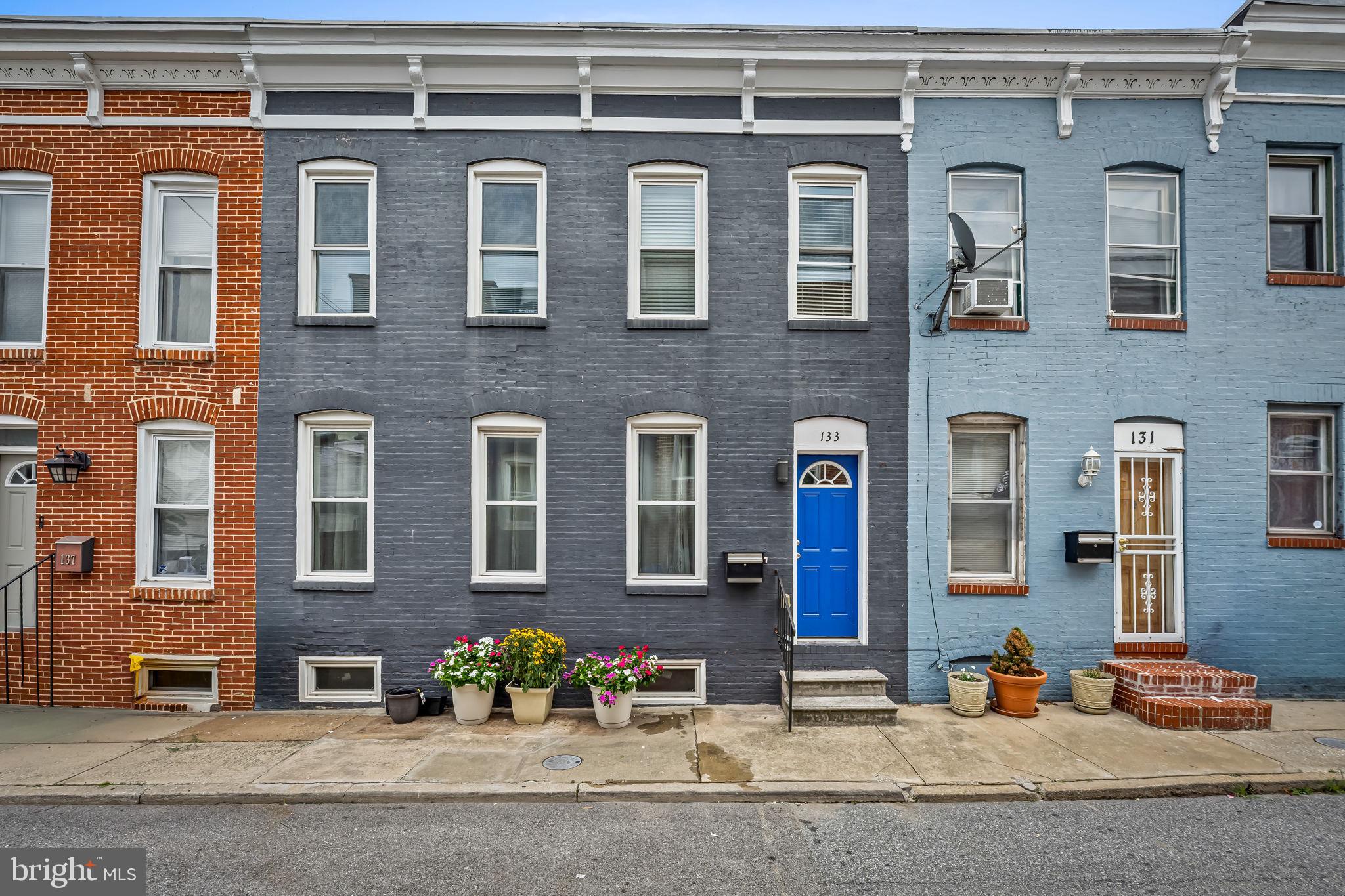 Exceptional Properties. Exceptional Clients. Rarely available in Patterson Park, this expansive home was created by thoughtfully combining two historic Baltimore rowhomes into one remarkable residence. Offering 4 bedrooms, 4 full bathrooms, private 2-car parking, and an unusually wide floor plan, this freshly painted home blends historic charm with the space and convenience of modern living.

Inside, exposed brick walls, generous living spaces, and abundant natural light create a home unlike the typical city rowhouse. The spacious living room is anchored by a stunning exposed brick fireplace, while the oversized kitchen features an expansive butcher-block island with seating for family and friends, creating an ideal space for gathering and entertaining. Stainless steel appliances, fresh paint, and dual-zone HVAC combine modern comfort with timeless Baltimore character.

The highly desirable main-level bedroom and full bathroom offer remarkable flexibility as a guest suite, home office, or multigenerational living space. Upstairs, spacious bedrooms and multiple full baths provide room for everyone without sacrificing privacy.

Outside, enjoy the rare convenience of off-street parking for two vehicles. Just steps away, Patterson Park offers miles of walking and biking trails, a swimming pool, tennis courts, a dog park, playgrounds, athletic fields, and year-round community events. Johns Hopkins Hospital, Canton, Fells Point, Harbor East, and downtown Baltimore are all just minutes away.

A one-of-a-kind Patterson Park home offering exceptional space, timeless character, and modern convenience in one of Baltimore's most sought-after neighborhoods.