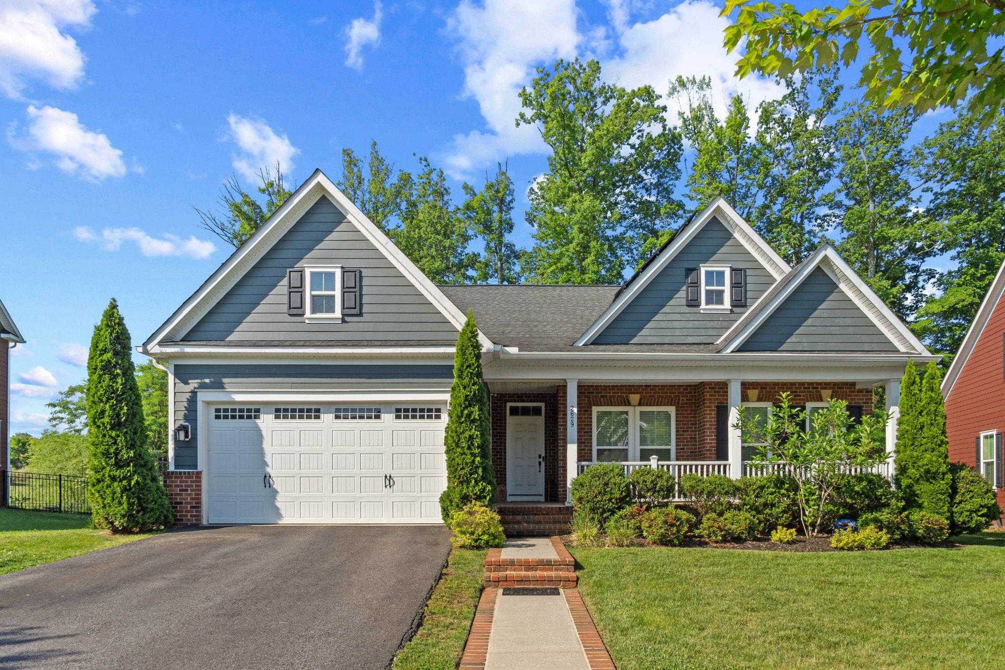 Enjoy main-level living at its finest with this Carolina Place model, ideally situated adjacent to woods for maximum privacy. The main level is spacious, with engineered hardwood flooring, an eat-in kitchen, formal dining room, and two bedrooms – including the primary suite with the optional bump-out for even more space. Downstairs in the finished walk-out basement, enjoy movie night with the built-in 7.1 surround sound system. Or, if you need to get some work done from home, retreat to the private office (could also be a third bedroom!) with insulated glass doors letting in tons of natural light. The lower level also has plenty of storage, with two massive unfinished storage rooms offering plenty of space to hide away your treasures. The current owners have added a multitude of upgrades and features to the home including a solar panel array, Vivint home security system, automatic front door lock, brand new carpet and LVP flooring in the lower level, built-in lawn irrigation system, EV charger in the garage, new water heater (2025), oversized gutters/downspouts, and steps off the back deck. Come see this beautiful home today because it will not last long!