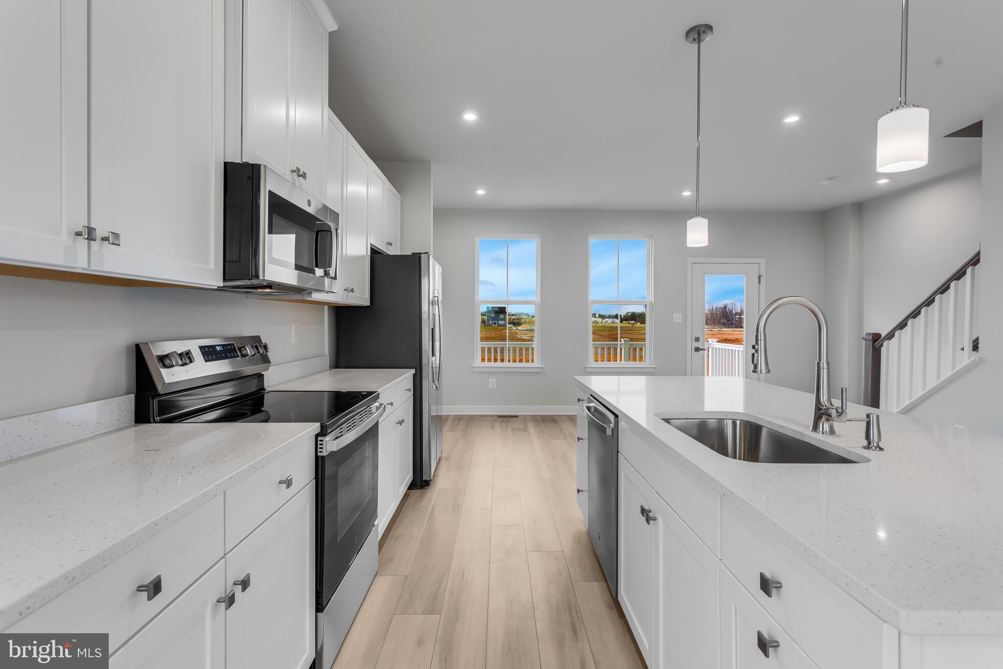 Welcome to this IMMEDIATE-MOVE-IN "Ballad" END UNIT at the brand-new MADISON GREENS community in Ranson, WV! Luxury townhomes that live like a single-family home with backyards and a prime location walkable to Potomac Towne Center and right off Rt. 9. You can be in and settled before school starts back up! Only 20-min from Frederick County, MD and 30-min from Loudoun County, VA. Step inside through the welcoming ground-floor foyer, leading to a versatile-oversized recreation room with a powder room. Upstairs, an expansive great room offers the perfect setting for relaxing or entertaining. The adjoining gourmet kitchen, complete with a generous island, walk-in pantry, and open dining area, makes cooking and gathering a true delight. On the third floor, discover two comfortable secondary bedrooms and a full bath. Retreat to your luxurious owner’s suite, featuring dual walk-in closets and a spa-like bath with double vanities. Every Ballad includes a private backyard — the perfect spot for enjoying fresh air or giving your furry friend room to play. Come visit us at: 1741 Destrier St, Ranson, WV, 25438