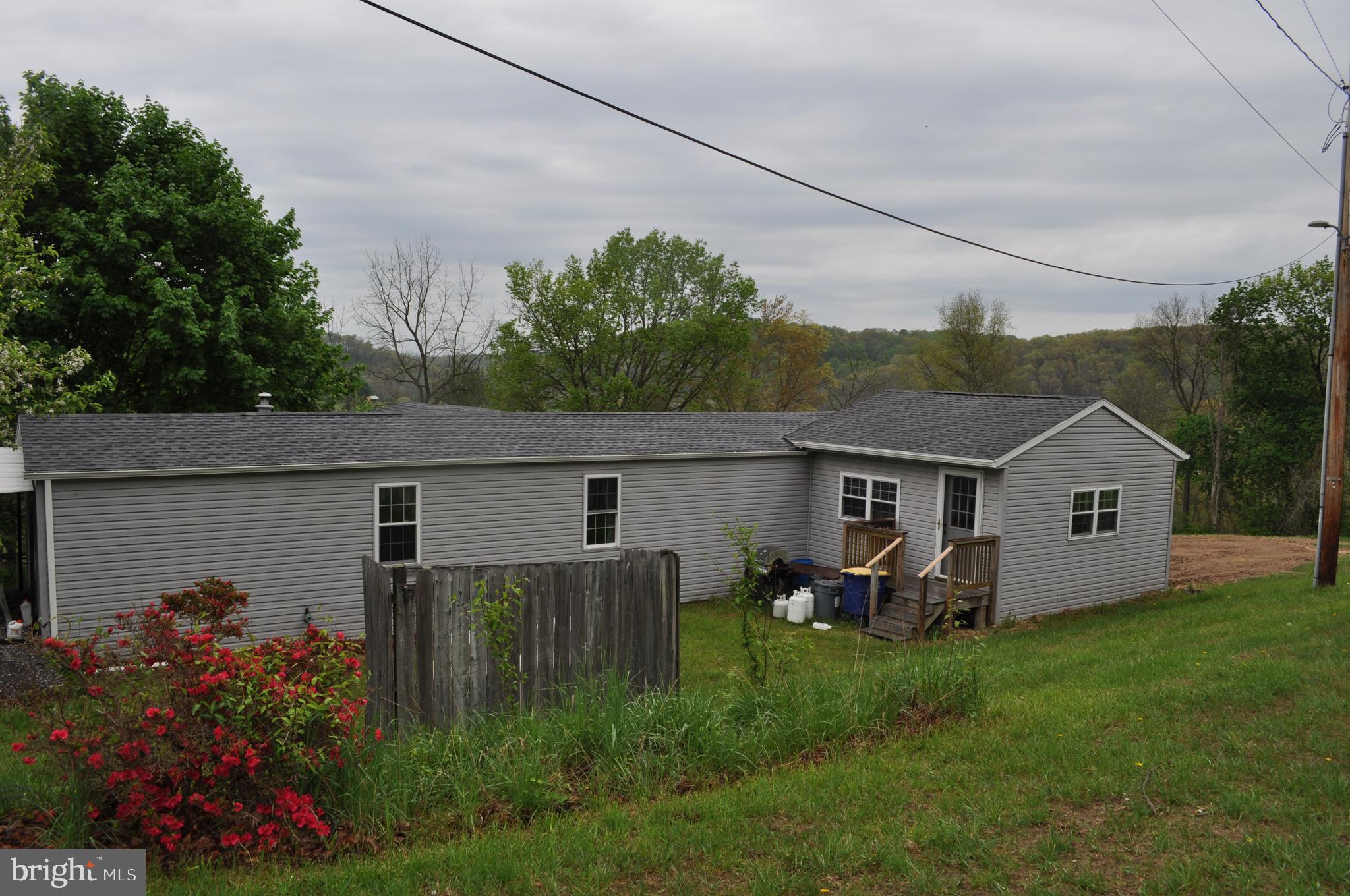 Enjoy the spectacular view  of the country side along  with  watching all the wild life from the 17x16 family room. Large Kitchen with center Island and breakfast bar.  Laundry closet includes washer and dryer. All appliances convey in as- is condition. Primary Bedroom with primary bath and Twin closets.  2 additional bedrooms and full bath.  Upon entry is a mud room with coat closet.  Upgrades include: Roof 2017.  Siding and windows 2009,  CAC 2017, Furnace 2019 1995 Imperial Mobile Home on Perminate foundation.  Title was surrendered for deed.