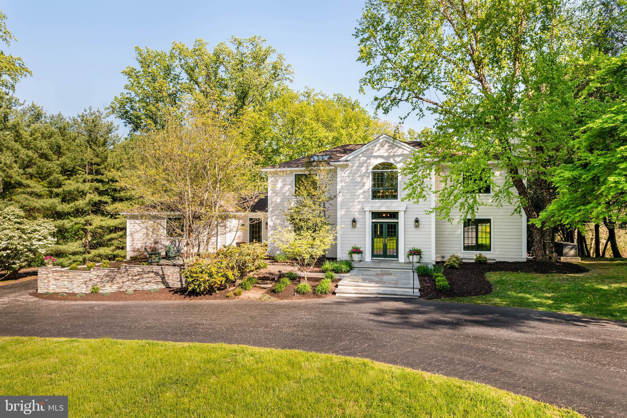 Make your move to this exceptional home, an ideal blend of effortless living, thoughtful design, and resort-style outdoor entertaining. Featuring NEW HARDIE PLANK SIDING, new gutters and downspouts, this residence offers both peace of mind and timeless curb appeal. Inside, generous living spaces, including a sought-after FIRST FLOOR BEDROOM and full bath, provide flexibility for today’s lifestyle, while the stunning backyard showcases a beautifully restored heated SALTWATER POOL.
Set on a lush 1.46-acre lot, this five-bedroom, three-and-a-half-bath home is tucked away on a PRIVATE LANE of four residences, offering both tranquility and space. Far from cookie-cutter, this property is truly one of a kind. The front yard enjoys serene, protected views of the Garrett Williamson Farm, ensuring lasting open space with no future development. Out back, a private oasis awaits, complete with mature landscaping, a flagstone-surround saltwater pool, stone fire pit with built-in seating, expansive patio, and a peaceful deck ideal for relaxing or entertaining.
Over the years, the owners have made numerous thoughtful upgrades that further distinguish this home. Highlights include new Hardie Plank siding, updated gutters and downspouts, a renovated front retaining wall, wide-plank white oak hardwood floors in the foyer and living room (matching the dining room and kitchen), a new AC unit, double ovens, refrigerator (included), patio slider, and select window replacements.
Comfort and convenience continue throughout with features such as skylights in the kitchen, office, and primary bath, radiant heated floors in all three full bathrooms and the laundry room, a whole-house water softening system with reverse osmosis drinking water, and an automatic propane-powered generator.
The main level welcomes you with a gracious two-story foyer. Just off the entry are a powder room, a formal dining room (currently styled as a library), and a spacious living room anchored by a custom wood-burning fireplace. Along the rear of the home, the sunlit Kountry Kraft kitchen, with stainless steel appliances, skylights, and a center island, opens seamlessly to a dining area with new sliders and a cozy family room with a gas fireplace, all overlooking the picturesque backyard. Off of the kitchen, a private first-floor suite includes an office, an oversized bedroom, and a full bath, perfect for guests, in-laws, or an au pair.
Upstairs, the expansive primary suite offers a peaceful retreat with a soaking tub, separate shower, and walk-in closet. Three additional bedrooms and a well-appointed hall bath complete the second floor. The finished lower level provides additional living space, along with a large laundry room equipped with two sets of washers and dryers.
Completing the package is an exceptional location, just minutes from shopping, dining, top-rated schools, Center City, the airport, and major commuting routes.