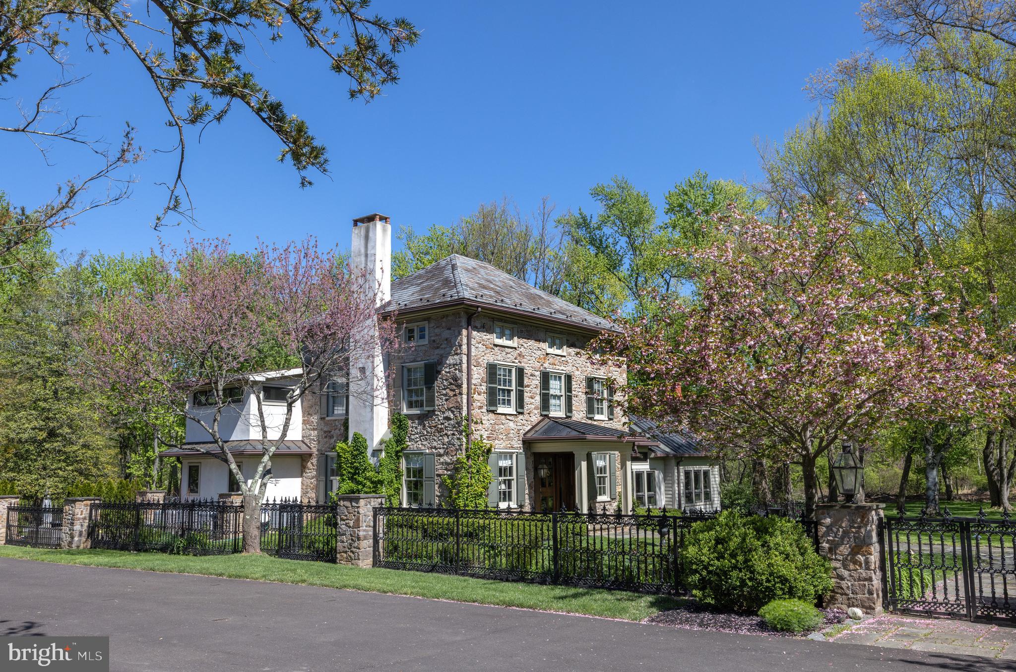 "Stonewell", 1851, is an exceptional example of classic Bucks County stone brought into the 21st Century with a modern addition. Set on 5 private acres, fully fenced and gated, the bucolic grounds are fully planted and handsomely landscaped with specimen trees, flowering perennials, and authentic stone hardscape.  Meticulously planned and maintained, this four bedroom home features the best of all worlds: rustic exposed stone interior walls, antique beams, hardwood floors with a modern, open main level complete with floor to ceiling folding Nana glass doors out to the sprawling slate patio, saltwater swimming pool, in-ground spa, bocce ball court, and more.  The custom gourmet kitchen features all stainless steel appliances, an oversized island full of storage, and flows effortless into the open plan dining area just off the terraced patio.  Full butler's pantry, main level home office, and ample sized formal living and casual family room and two fireplaces round out the main level, and don't miss the hidden antique well featured in the floor! Upstairs there are 4 bedrooms, all of which enjoy nice proportions and the primary bedroom features a large en suite bath complete with antique copper soaking tub and walk-in shower. The top floor bedroom could also make a nice bonus room and comes with an en suite full bath. A custom metal gazebo and fire pit are located in the back of the property, perfect for soaking in the sunsets.  Detached three car garage and shed with chicken coop.  Gated entrance, truly a private retreat setting yet just minutes to the historic Solebury villages of Carversville, Lumberville, New Hope Borough, Doylestown and convenient to the greater Delaware Valley, NYC, Philly areas.  Truly a must-see!