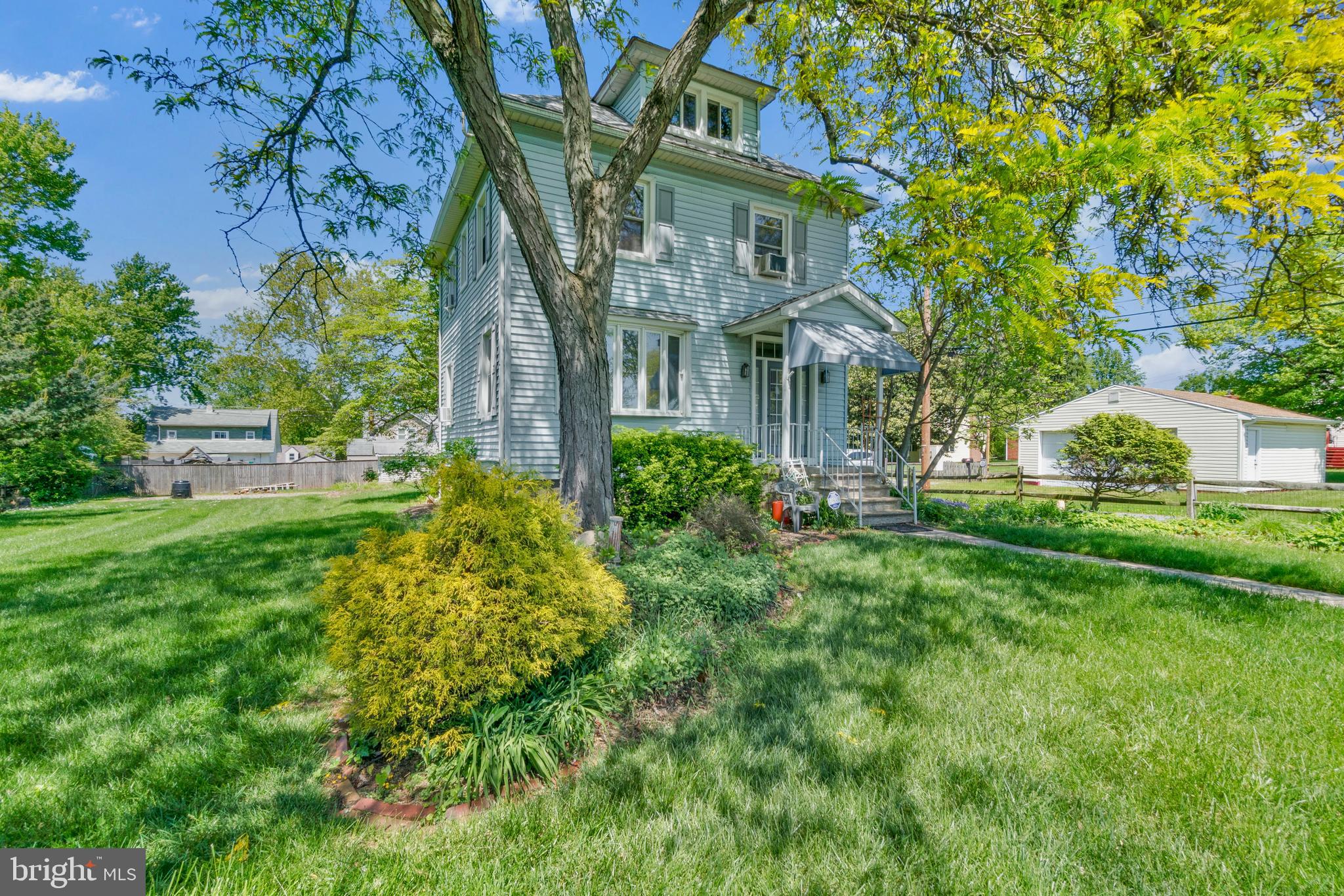 Stately Colonial home in Woodlawn Park, offering a peaceful retreat surrounded by lush perennial gardens across an expansive property. Picture hosting gatherings on the brick patio, unwinding on the covered porch, or strolling through vibrant, blooming flower beds.

Inside, you’re welcomed by a gracious foyer featuring original wood trim and a classic newel post staircase. The main level feels warm and inviting, with tall ceilings and abundant natural light throughout. Luxury vinyl plank flooring leads into the living room, complete with cherry built-ins, while the spacious dining room easily accommodates a large table and buffet, with views of the side and rear landscape.

The kitchen offers a functional layout with ample counter space, ideal for everyday cooking and entertaining. Upstairs, the primary bedroom spans the full width of the home and features carpeted floors. The second and third bedrooms showcase hardwood flooring, with the third offering access to the rear addition rooftop—an opportunity to create a future balcony. The upper-level bathroom is finished in tile and includes a shower.

From the primary bedroom, a fixed staircase leads to the attic, providing convenient storage along with a large cedar closet. The partially finished basement adds valuable living space, including a recreation room, second full bathroom, and laundry area.

Outside, the detached garage has been converted into a workshop, offering flexibility for a skilled buyer to use as-is or convert back to a traditional garage. Recent updates include an architectural shingle roof on the home and a traditional shingle roof on the garage.

The home is being sold strictly as-is, and the seller will make no repairs. The property will be listed as active prior to the consideration of any offers. Offer Deadline Monday 5/11 at Noon.