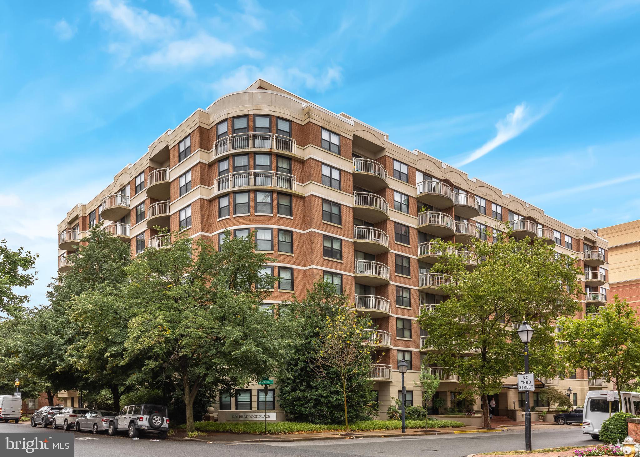 We just found your new spot to unwind - your private balcony at your new home, just moments away from Old Town Alexandria. Presenting 1200 Braddock Pl, Alexandria, VA—a stunning 2-bedroom, 2-bathroom condo spanning 1,043 square feet of comfortable yet stylish living space. This residence features elegant hardwood floors, enhancing its open and airy atmosphere. Off the living room, you are  connected seamlessly to the dining area and modern kitchen, making hectic weeknight dinners a breeze. 

Through the hallway you'll find closet and cabinet spaces that are equipped for all of your storage needs, especially in a condo! The primary suite includes a private bath, while the second bedroom offers flexibility for guests or a home office. This unit offers central heating and cooling for year-round comfort, and the convenience of an in-unit washer and dryer adds to the ease of living.

Building amenities are exceptional, featuring a well-equipped gym for your fitness needs and a luxurious pool area with a hot tub and sauna, just in time for the spring and summer months ahead. A comprehensive security system adds peace of mind as one of the other many condo fee inclusions. 

Parking is a breeze, with one assigned space in the garage and an additional surface assigned space only steps away from the back door. Situated in one of the most desired places in NoVA, this building is located just one block away from the Braddock Road Metro (Blue/Yellow lines) for easy access. You are also a mere 5 minute walk to Old Town Alexandria, offering you history and city living without the hassle. Get groceries at Trader Joes or dine at crowd favorites like Lost Dog Cafe, Hanks Oyster Bar and much more. 

Your new life of relaxation and convenience awaits at 1200 Braddock Pl #216!