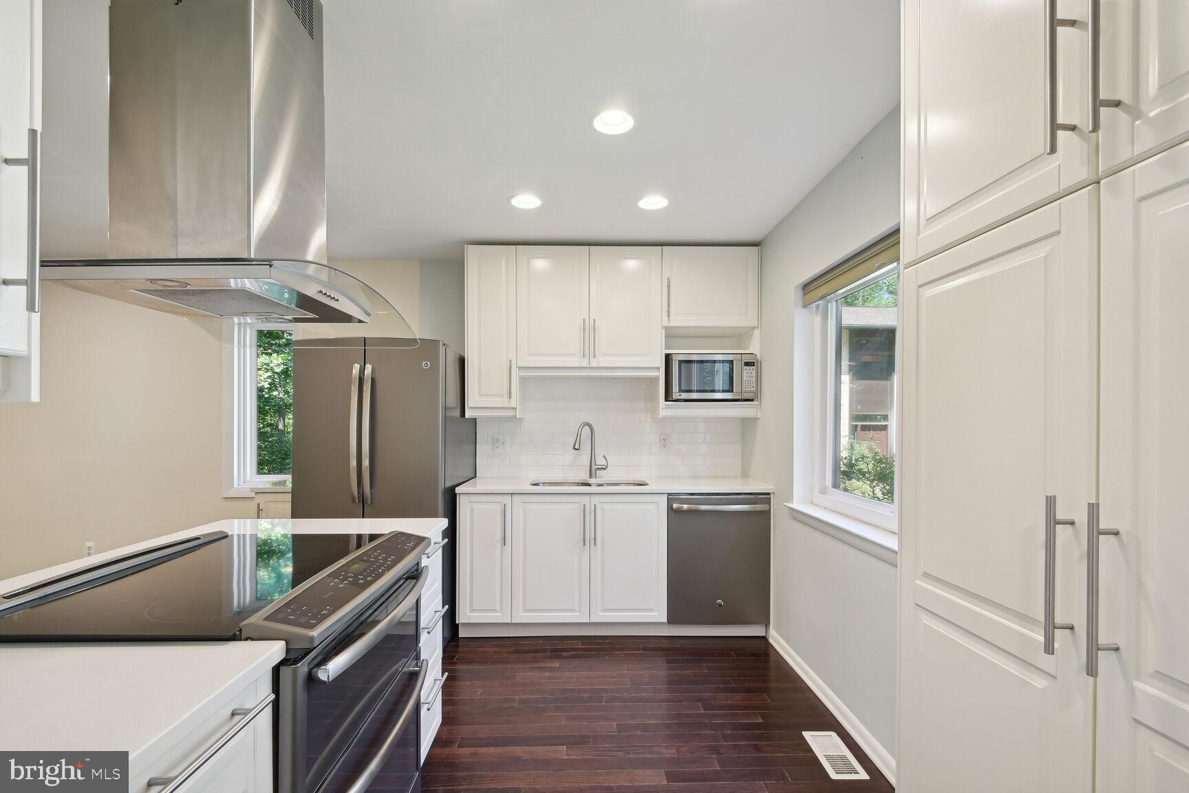 Presenting this renovated 3 BR / 2 BA / 2 1/2 BA End Unit Townhome With Two Dedicated Parking Spaces in Reston that backs to woods and privacy! Upon entry to home, you are met by remodeled open floor plan concept that includes powder room, coat closet, living and dining room combination with hardwood flooring and renovated kitchen with walls removed to further open the floor plan. Kitchen includes 42" white cabinets, extra pantry space, stainless appliances and hardwood flooring to remain consistent with the rest of the main level. Off the living and dining area is exterior access to deck that provides serene and unencumbered views of the woods and space for morning coffee and exterior entertaining. Upstairs, there are three generously sized bedrooms, including primary bedroom that has a brand new renovated primary bathroom with tile flooring, new vanity with granite and stand in shower with tile and glass door. Second bedrooms share second brand new full bathroom with tile flooring, new vanity and soaking tub / shower combination with tile. Basement is walk out level that provides extra interior living space, second half bathroom, unfinished storage area with laundry and exterior access to private downstairs deck. The Reston community includes pools, tennis courts, playgrounds and trails. Neighborhood school pyramid is Terraset / Langston Hughes / South Lakes and is very near Hunters Woods shopping center, which includes grocery, coffee shops (Starbucks and Dunkin'), restaurants, retail and the Reston Community Center. It also has many Fairfax Connector Bus Stops nearby for public transportation purposes and connects to major commuting roads Reston/Fairfax Parkways, with close proximity to the Toll Road for commuting East to DC or West to Ashburn. Neighborhood is located within 10 miles of Dulles Airport, 3 miles of Reston Town Center, which now includes Reston Town Center Silver Line Metro Station, 2 miles from Wiehle-Reston Silver Line Metro and 2 miles from Halley Rise development that includes now open Wegmans. Enjoy all live, work and play elements of Reston!