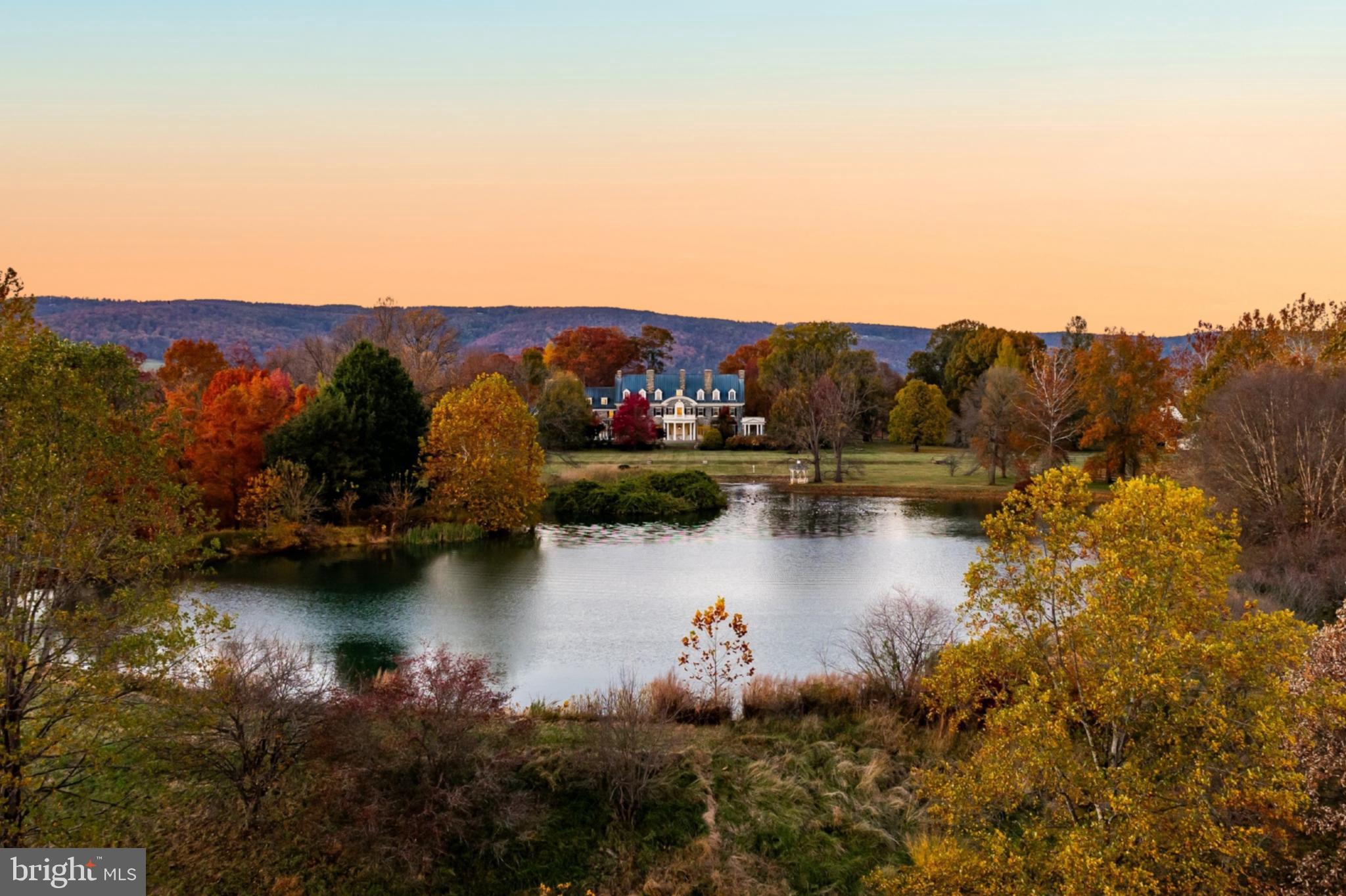 Set amid the picturesque countryside of Upperville, Virginia, Ayrshire Farm rises from the landscape with a presence that feels both timeless and stately. Encompassing 571 acres in the heart of the Virginia Piedmont, the estate is rich in heritage, design, and purposeful land stewardship. Few properties in the region balance these elements with such ease or at this scale.
 
The manor house, completed in 1912, stands as the estate’s architectural anchor. Constructed of fieldstone quarried from the property, its four-foot-thick walls and steel-reinforced structure were bold innovations in their day. The residence carried the rare distinction of offering electricity, indoor plumbing, and central heating at a time when such comforts were little more than distant ideas for most of the country. More than a century later, its original cypress windows, beams, and intricate masonry speak to a standard of craftsmanship that endures with remarkable clarity.

In recent years, the home has undergone a careful and comprehensive restoration, bringing modern performance and convenience to its historic framework. Its 17,000-square-foot interiors have been methodically rewired and re-plumbed, outfitted with three-phase power, central air, underground utilities, and a sophisticated security and communication system. Twelve restored fireplaces, finely calibrated lighting, locally crafted cabinetry, and an English conservatory designed by Glass Houses of England reflect a discerning approach to preservation. The materials, textures, and architectural details that define the residence create an atmosphere of quiet grandeur, grounded in authenticity rather than overt opulence.
 
Ayrshire Farm’s influence extends far beyond the manor. The property became the first in Virginia to achieve both Certified Humane and USDA Certified Organic status, marking a defining moment in the state’s agricultural landscape. Its fields, orchards, and pastures continue to support working organic operations, helping shape regional standards for sustainable and ethical farming. This commitment to the land is not ornamental; it is foundational to the estate’s identity.
 
The natural setting surrounding the home is as compelling as its history.  Upperville’s storied equestrian traditions blanket the landscape with a quiet sophistication unique to the Virginia Piedmont. Located just 65 miles from the heart of Washington, DC, and 35 miles from Dulles International Airport, Ayrshire offers a sense of escape without isolation. The charming village of Middleburg, with its boutiques, cafés, and equestrian heritage, lies only a short drive away, placing everyday conveniences and refined country life within effortless reach. To the west, the ridgelines of the Blue Ridge Mountains and the expanse of Shenandoah National Park form a dramatic horizon.
 
Artists and filmmakers have long been drawn to this terrain, captivated by its pastoral simplicity and sense of permanence. Alfred Hitchcock’s Topaz was among the works filmed on the estate, a testament to the property’s cinematic presence.
 
Today, Ayrshire Farm stands as one of the region’s most significant estate holdings, a rare convergence of architectural provenance, ecological leadership, and natural beauty. It is a property defined not only by its past, but by the clarity of its vision. In an area known for remarkable estates, Ayrshire remains singular, offering a balance of history, purpose, and place that feels both beautifully rooted and unmistakably relevant.