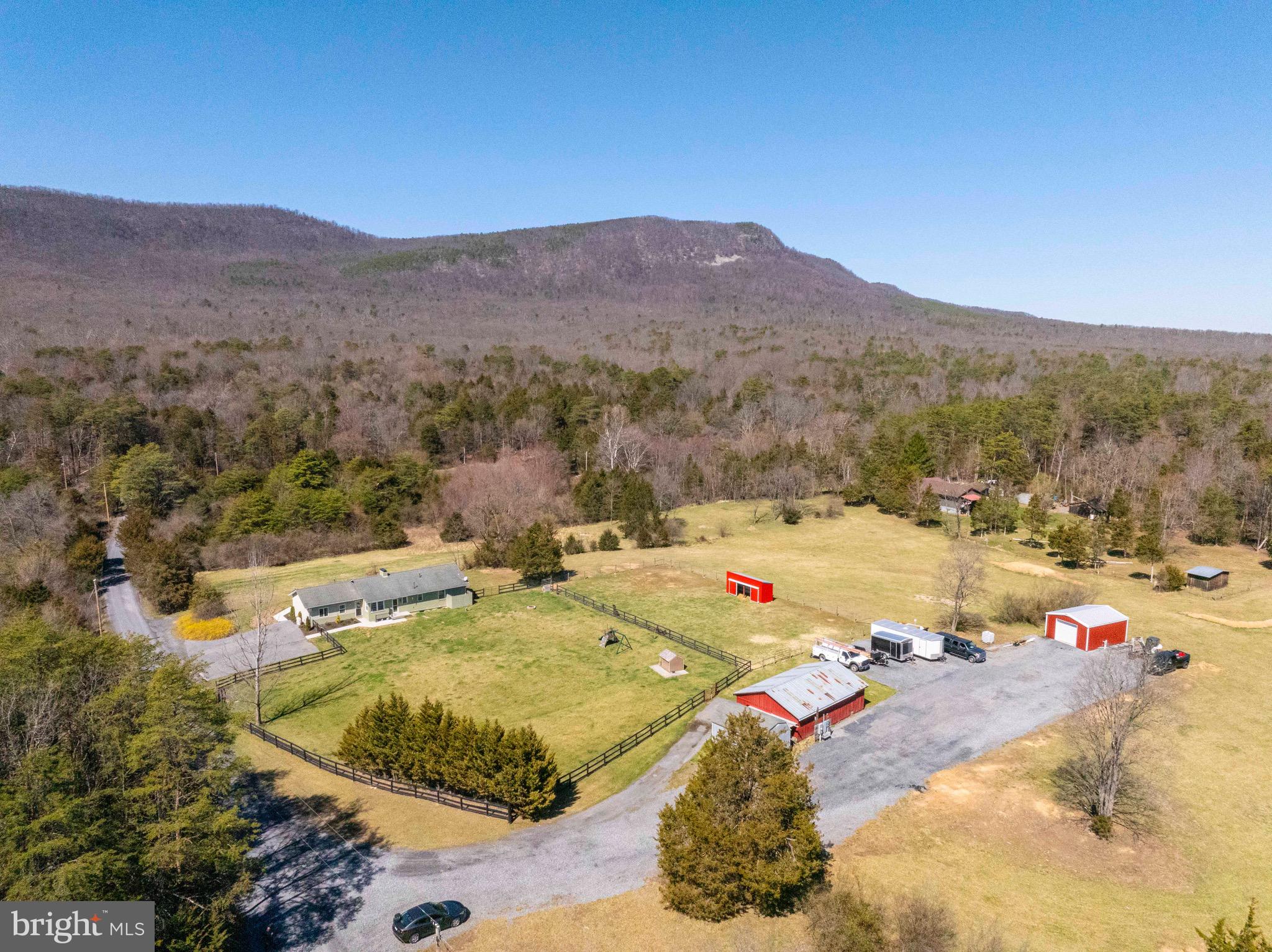 Welcome to this beautifully maintained property at 5172 Panhandle Road, perfectly situated on 7 acres in Front Royal, Virginia. Whether you're looking for a cozy retreat, a hobby farm, or a place to settle into a vibrant community, this property offers it all!
Boasting 5 bedrooms and 3 bathrooms, this spacious home provides plenty of room for comfortable living. The layout creates a warm and inviting atmosphere, with abundant natural light streaming through large windows. The well-equipped kitchen features modern appliances, ample storage, and a convenient breakfast nook.  The private primary bedroom suite feels like resort living!
Step outside and enjoy the stunning mountain views of the George Washington National Park, and the spacious fenced back yard is ideal for enjoying the outdoors or hosting summer BBQs.  
A separate entrance provides access to multiple outbuildings including a 36x24 powered barn, a 24x24 powered workshop, a 20x12 storage shed, and run-in shed for animals or recreational toys.  With its prime location, you’ll appreciate the peaceful, yet accessible, setting – offering the perfect balance of privacy and convenience.
This home is priced well below a recent appraisal, and has over $300K in recent improvements including the kitchen, bathrooms, primary bedroom suite, state-of-the-art water filtration system, dual zone HVAC, two water heaters and brand new 400 amp service at the house and workshop.
Don’t miss out on this fantastic opportunity to make 5172 Panhandle Road your new home. Schedule a showing today and experience all that this exceptional property has to offer!