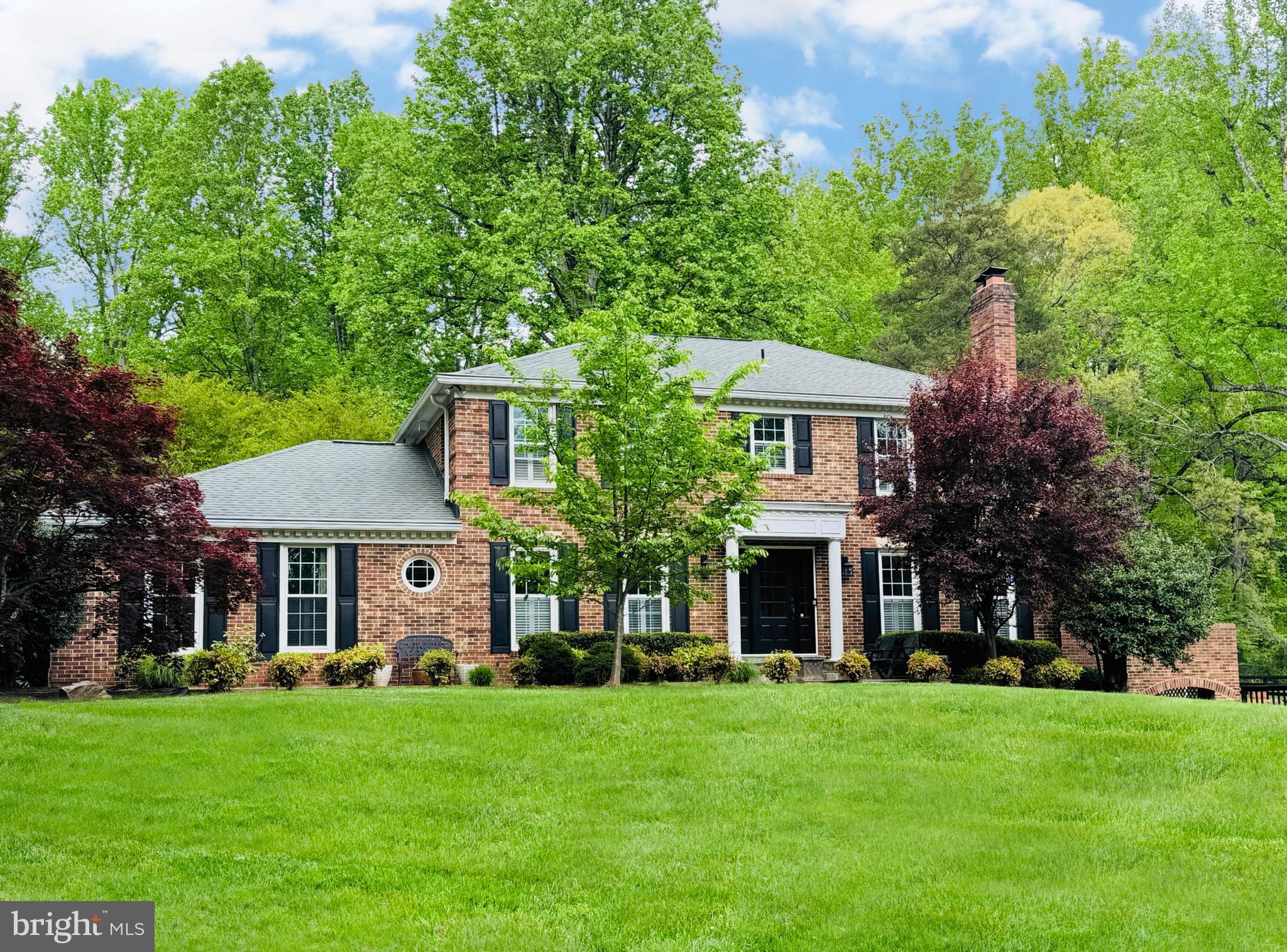 Equestrian Living meets Elegance in this 4 bedroom, 3.5 bath all brick Colonial in Fairfax Station. So much love has been poured into this home by its current owners. Privacy abounds on the luscious 5 acre lot as the home is tucked back off the road in the sought after community of Lakewood Estates. As you come up the long driveway prepare to be amazed by all this home has to offer. As you come up the stone walkway and through the beautiful front door you'll find nearly new hardwood floors on the main and upper levels.  Main level Powder room updated just last year. Family room boasts a huge stone fireplace, built-in bookshelves and a bar for entertaining. The spacious kitchen has plenty of room for an oversized table, Island with seating, new textured Granite countertops, Stainless steel appliances, copper sink, 2-pantries, Cherry cabinets and recessed lighting. An over the cooktop pot rack is perfect for all the Gourmet cooking you’ll do in this home. Step out into the 4-season Sunroom addition added on to the home in 2018 complete with skylights, ceiling fan and TV. You’ll never want to leave this cozy room as it has views all around the Amazing yard. Covered porch off the sunroom is great for warm or cold nights. Built-in BBQ grill there conveys. Don’t forget to check out the main level laundry room w/dog bath, cabinets and small seat for putting on or taking off your shoes. Charming living room with lots of light and wood burning fireplace. The formal dining area leads out to the side deck with bar, plenty of seating and awning overlooking the pool. Spacious bedrooms on the upper level. Primary Bedroom has 2 closets and barn door leading to the recently remodeled primary bath w/double sinks, Corera marble sink top and shower seat,  heated floors and private water closet. There are 3 other generous bedrooms w/lots of light and good closet space. Secondary upper bath has been recently updated too. In the Recreation room in the basement you’ll find ceramic tile floors, another wood burning fireplace, Kitchenette, large room that could be used for an office or 5th bedroom, Big Cedar closet, full bath with shower and soooo much storage. 
The outside of this home is like a dream come true!! Amazing pool with Dolphin feature that acts as a water fountain, beautiful decking around the pool and spa area. Mature trees are found all over this lot with a huge Poplar Tree taking center stage. Pool House has its own Full Bath w/Shower, Bar area for entertaining, kitchenette and seating area. All you need now is a few drinks to get the party going. There’s plenty of room in the 4-car tandem garage for not only your cars but additional storage too! Two-stall barn w/tack room and storage area is perfect for your horses. There’s a 50x50 pen off the barn and a 60’ round pen in the front pasture. Horse trails are nearby, close to Fountainhead Regional Park, the charming town of Clifton and all its wonderful restaurants and shops and so much more. Seller replaced all attic insulation in 2022. The Best schools, close to all the major commuting routes plus the Burke VRE is nearby. There’s also a whole home generator and pool heater that is run off a leased propane tank. This truly is the home you’ve been waiting for…