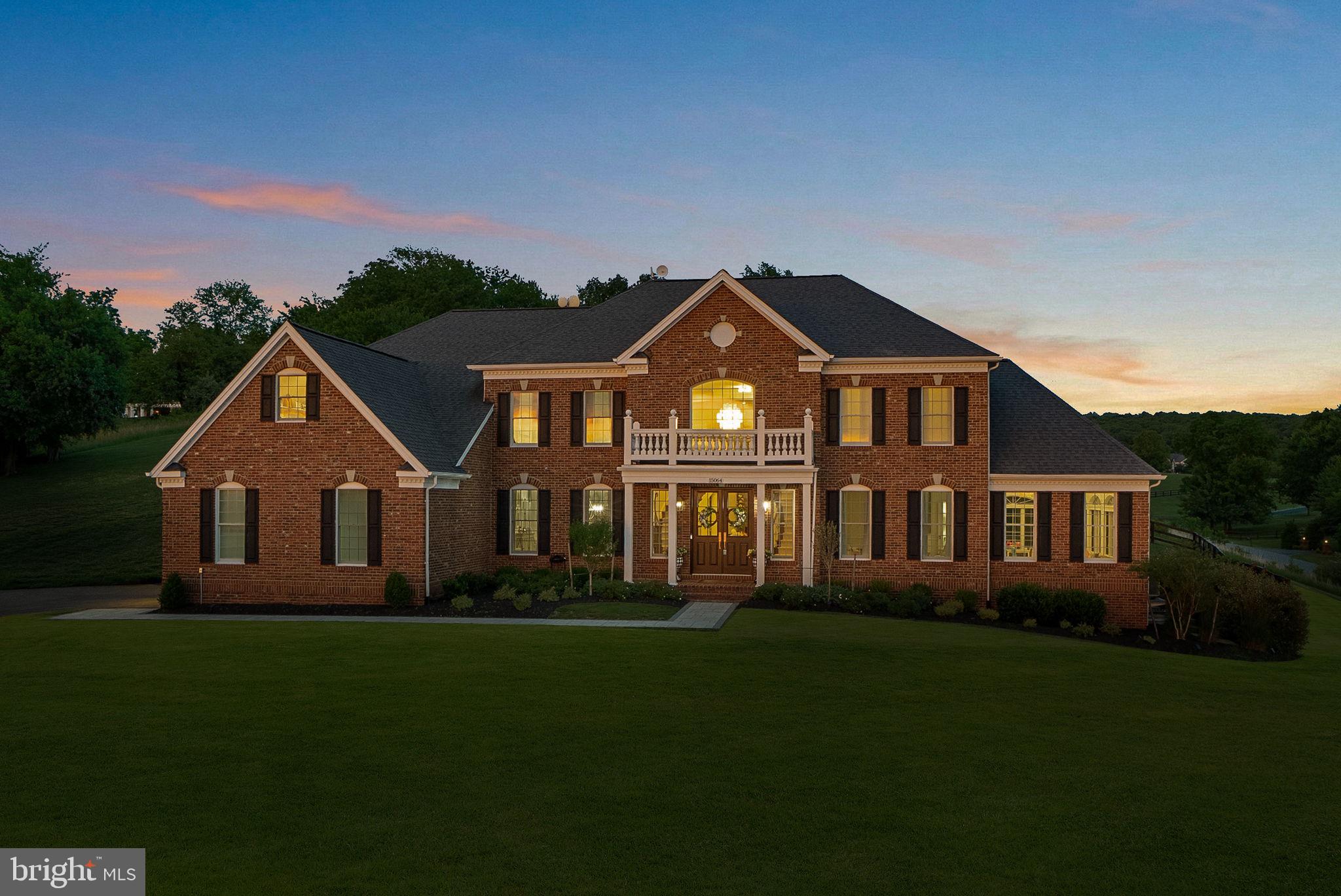 Price improvement on this Gorgeous Estate with Blue Ridge Mountain Views set on 3.06 acres in Western Loudoun County . This exquisitely renovated estate offers nearly 8,300 square feet of luxurious living, thoughtfully designed to capture both natural beauty and architectural presence; offers the rare balance of peaceful countryside living with remarkable everyday convenience. Just minutes from major commuter routes ie. Rt 7, Rt 9, and the Dulles Greenway, the property is approximately 30 minutes from Dulles International Airport and within close proximity to shopping destinations such as Whole Foods, Wegmans, Costco, Target, Trader Joe’s, Leesburg Premium Outlets and more. Residents enjoy easy access to acclaimed wineries, charming floral gardens and flower farms, fine dining, schools, and the historic villages of Waterford and Leesburg.
A grand arrival begins with new double entry doors opening into a dramatic two-story foyer, where a striking double-sided curved staircase creates an unforgettable first impression. From this central vantage point, the home immediately reveals its scale and intentional design. Formal living and dining rooms gracefully flank the foyer, while a sun-drenched conservatory and expansive windows fill the home with natural light throughout the day. At the heart of the home, the gourmet chef’s kitchen is both sophisticated and functional—anchored by an impressive 11-foot island with seating and appointed with a curated suite of Café appliances, including a French-door wall oven, built-in microwave, French-door refrigerator, a custom vented hood, and 36-inch commercial-style gas range. The kitchen also features an expansive Breakfast Room area that easily accommodates a table for 12, as well as a built-in desk area that adds convenience for daily living. Designer lighting and hardware, marble tile and luxurious countertops complete the space, while the adjoining Sunroom and the Breakfast Area overlooks the grounds and opens to a new Trex deck, seamlessly connecting indoor and outdoor living and leading to a beautifully crafted flagstone patio. The main level is completed by a 2-story family room, back stairwell to the upper level, private office, mudroom, and laundry room, plus powder room, thoughtfully designed with elevated finishes to reflect the home’s cohesive sense of luxury.
Upstairs, the primary suite serves as a true private retreat, offering both scale and thoughtful design. The suite features a separate sitting area, a generously sized secondary walk-in closet (approximately 9' x 7') within the bedroom, and an exceptional primary dressing room accessed through the ensuite bath measuring approximately 24 feet by 10 feet—creating a boutique-style wardrobe experience rarely found in residential design. The spa-inspired bath is equally impressive, showcasing a freestanding soaking tub, dual vanities positioned opposite one another, TWO water closets, and a double walk-in shower—delivering a retreat-like experience within the home. Three additional bedrooms and fully renovated ensuite bathrooms continue the home’s elevated design throughout the upper level.
The fully finished lower level, spanning approximately 2,600 square feet, offers exceptional flexibility for multigenerational living and/or entertaining. This level features a second gourmet kitchen with a 10-foot island, expansive living and entertaining areas, a private suite with custom walk-in closet and ensuite bath, two additional bedrooms with shared full bath, storage, media room, and additional flexible spaces. Direct walk-up access provides seamless connection to the backyard. Outdoors, enjoy over 3 acres of peaceful countryside, including a 1-acre fenced yard with a county-approved pool fence and gates, offering both privacy & future potential.
New: Hot Water Heater. 2 HVAC. Well Pump. Double Front Entry Doors. Hardscape. Workshop. Extensive Renovations. Plus more.