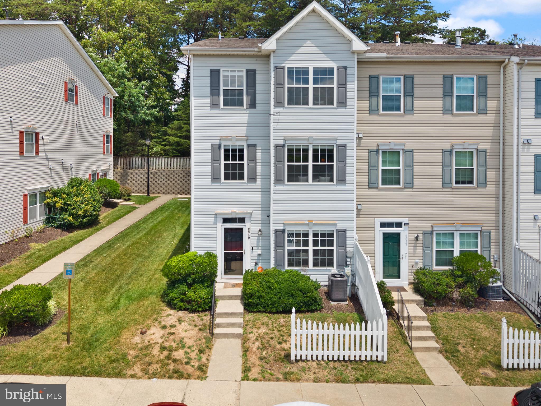 Welcome to 8049 Brookstone Court, a spacious end-unit townhome offering three finished levels of comfortable living in the heart of Severn. From the charming white picket fence curb appeal to the common area and tot lot directly in front of the home, this property offers the perfect blend of charm, space, and convenience.
The main level features 9-foot ceilings, large windows that fill the home with abundant natural light, and an open-concept floor plan with expansive living and dining areas that flow seamlessly into the kitchen, creating an ideal space for both everyday living and entertaining. A private powder room adds convenience for guests. The second level also boasts 9-foot ceilings and offers two generously sized bedrooms and a full hall bathroom. The entire third level is dedicated to an impressive primary suite featuring vaulted ceilings, a spacious walk-in closet, and a luxurious spa-inspired en-suite bathroom complete with a soaking tub, glass-enclosed shower, dual-sink vanity, and linen closet. With its thoughtful layout, bright and airy living spaces, and desirable community setting, this home is one you won't want to miss.