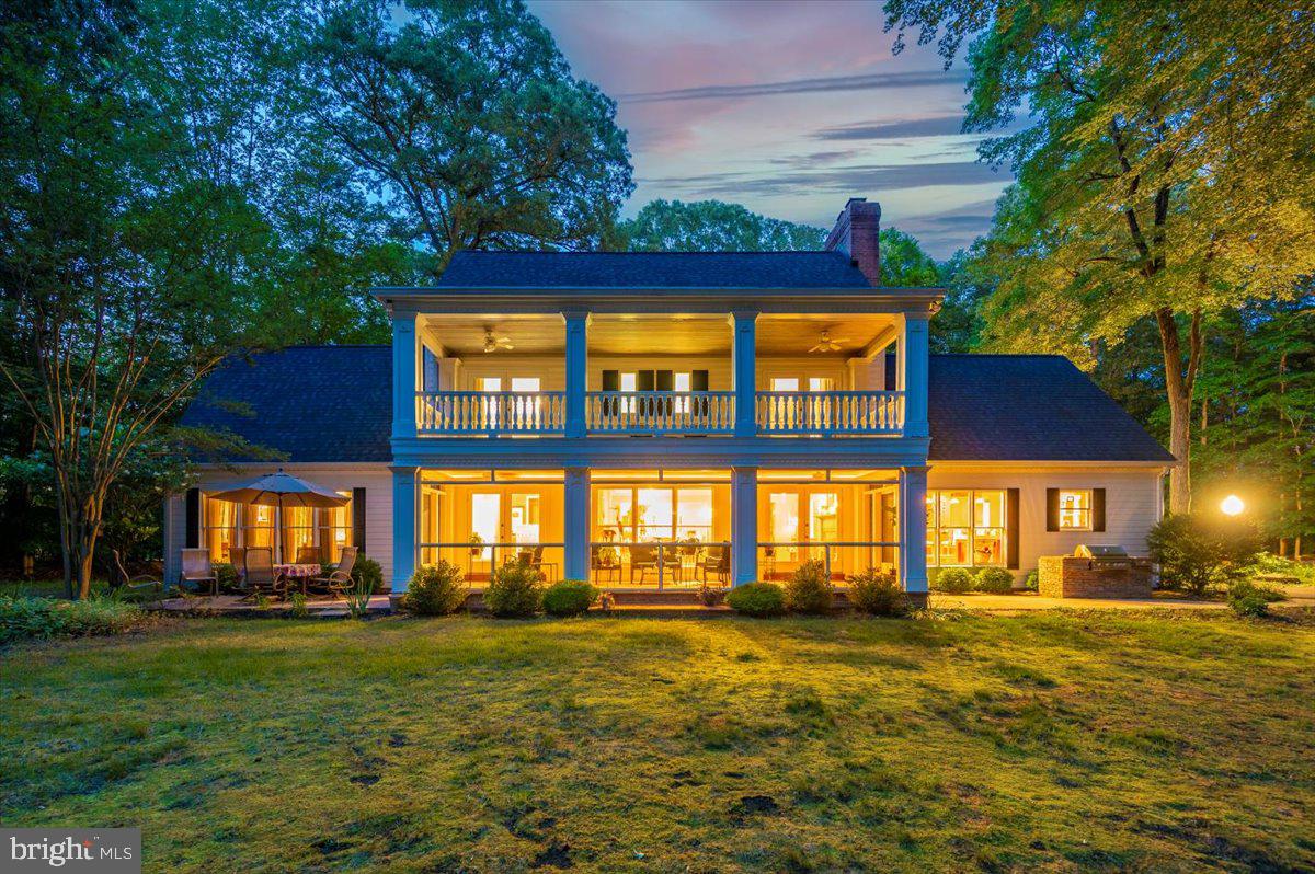 Welcome home! The sunrises are amazing and the sunsets are inspirational in this five bedroom, architect-designed,  two-level colonial that sits nestled in privacy along Lyons Creek and the Patuxent River amid 5.8 acres of woodlands and waterfront. Includes a private pier/dock with a boat lift as well as community boat dock. Massive kitchen and living room with multiple attached porches and patios are perfect for entertaining.  Three  of the Five  bedrooms (including the large downstairs owners’ suite & 2 west-facing bedrooms upstairs),  have open views of Lyons Creek and the Patuxent River.  Check out the upper and lower verandahs perfect for contemplative morning coffee times or evening reading with a glass of award wining wine.  House is much larger and still has second areas that could be turned into additional living space.
The  upstairs bedrooms each come with walk-in closets,  private entries to the covered verandah, and a jack-and-jill bathroom. The third upstairs bedroom is east-facing and spacious with an extra large walk-in closet, and an even larger adjacent unfinished attic space that has many potential uses. The downstairs guest bedroom is east-facing and adjacent to a large, well-lit rec room with wood-burning stove and private entry. It also has direct access to a full-size bathroom with a jacuzzi tub. This guest bedroom can alternatively be used as a downstairs private office. 
The modern kitchen is well-equipped with spacious granite countertops, a 6-burner Viking gas stovetop, Wolf multi-function full-size oven, built-in CAFÉ Advantium microwave & convection oven, Kenmore dishwasher, abundant oak cabinetry and floors throughout, built-in kitchen desk, and a large refrigerator that blends seamlessly with the wooden cabinetry. The house is designed with  gatherings  in mind, and the open-plan, eat-in-kitchen, and adjacent living area share an awesome 2-sided fireplace (originally woodburning, converted to gas). The downstairs owners’ suite includes a large  bedroom, two walk-in closets, and an adjacent bathroom suite with heated stone tile floors, a soaking tub with waterfront views, a stone tile shower, individual his and her sinks, and a privacy closet with toilet and a separate sink. 
An additional ‘hobby room’ provides a 2nd refrigerator and additional cabinets and countertop spaces, as well as a built-in ironing board, for crafting and storage. This room adjoins the spacious laundry room next door which has additional storage cabinets. Beyond the laundry room, there is an additional climate-controlled storage room for cleaning and maintenance supplies.
 For vehicles and additional storage, there is a detached 3-car garage with an open upstairs loft space. The garage includes an attached fully-enclosed garden shed on one side, and an attached carport on the other. The Patuxent Palisades neighborhood is a highly desirable community.  The  neighborhood amenities include a shared park with  pond, paved walking trail, play equipment, and tables and chairs for picnicking; a boat dock on the Patuxent River; and seasonal community activities. 
 Experience and view the wonder of  nature  with bird-watching, boating, kayaking, canoeing, paddleboarding, water-skiing, hiking, camping, and fishing available right in your backyard. This easy to maintain 5.8 acre lot offers plenty of room for exploring.  The Chesapeake Bay is less than 15 miles to the east, and Washington DC is only 30 miles to the northwest. For the everyday necessities,  Dunkirk Town Center, with  three grocery stores and all the other services, is just minutes away .  Schools are close by as well. Check out the community park. Community has a gated private dock access for larger boats.
Call your Realtor and come see this unique and delightful property.