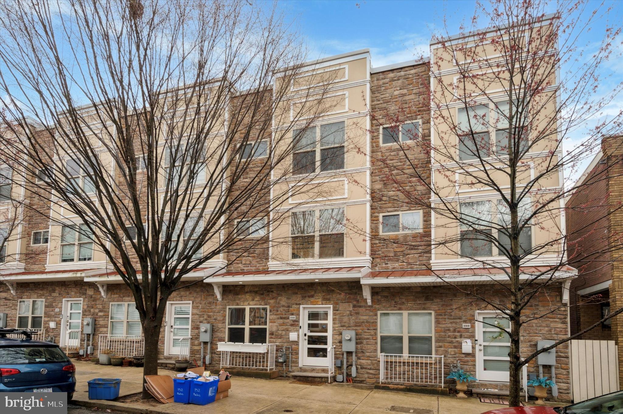 Just Listed- Modern Elegance in Manayunk. 152 Kalos Street is a spacious contemporary townhome. This stunning, light-filled contemporary townhouse in Manayunk, offers over 3,300 square feet of luxurious living space with three spacious bedrooms, 3.5 baths, and two private outdoor areas. Built in 2017, this home has two years remaining on the 10-year tax abatement, making it an exceptional opportunity.
Step inside to an open-concept main level, where the living and dining areas seamlessly flow into a stylish, modern kitchen. Floor-to-ceiling windows flood the space with natural light, complementing the warm grey Lauzon hardwood floors and LED lighting throughout. The living area is anchored by a 42" Napoleon gas fireplace, while the sleek kitchen boasts custom cabinetry, pure white quartz countertops, a glass backsplash, Samsung stainless steel appliances, and a spacious island—perfect for entertaining. Sliding glass doors lead to the rear patio, expanding your living space outdoors. A convenient half bath completes this level.
The second floor features two generously sized bedrooms, each with ample closet space and abundant natural light. This level also includes a full bath, a dedicated laundry/utility room with utility sink, and continued hardwood flooring throughout.
The third floor is dedicated to a private owner’s suite, featuring two large closets, a separate vanity area, and a luxurious spa-inspired bath with a soaking tub, oversized shower, double sinks, and a private toilet area.
The fourth level is an entertainer’s dream—an expansive full-length roof deck equipped recently with a 3-year warranty) with two distinct areas for relaxing, hosting guests, or taking in breathtaking sunsets. The deck also includes a convenient outdoor water spigot. The fully finished lower level offers an additional 720 square feet of versatile living space, a full bath, a utility room, and direct access to the built-in one-car garage, which includes an additional outdoor water spigot. An exterior parking space adds to the home’s convenience. This home is equipped with two-zone HVAC, managed by Lennox iComfort smart thermostat with wireless control through an app. Also comes with a Culligan Smart High Efficiency Water Softener which can be controlled & monitored through an app. Located just 0.2 miles from the SEPTA Wissahickon Train Station—a quick three-minute walk—this home provides effortless access to Center City, the Schuylkill Expressway, Kelly Drive, City Ave, and Main Street in Manayunk. One block from La Noce Park with a playground for kids and grassy area for dogs. 10-minute walk to Cook-Wissahickon school & Wissahickon Valley Park. Within 2 miles of five major grocery stores, Target, Panera, Chipotle, Chick-Fil-A, and more. Don’t miss this rare opportunity to own a modern, move-in-ready townhouse in one of Philadelphia’s most desirable locations!
