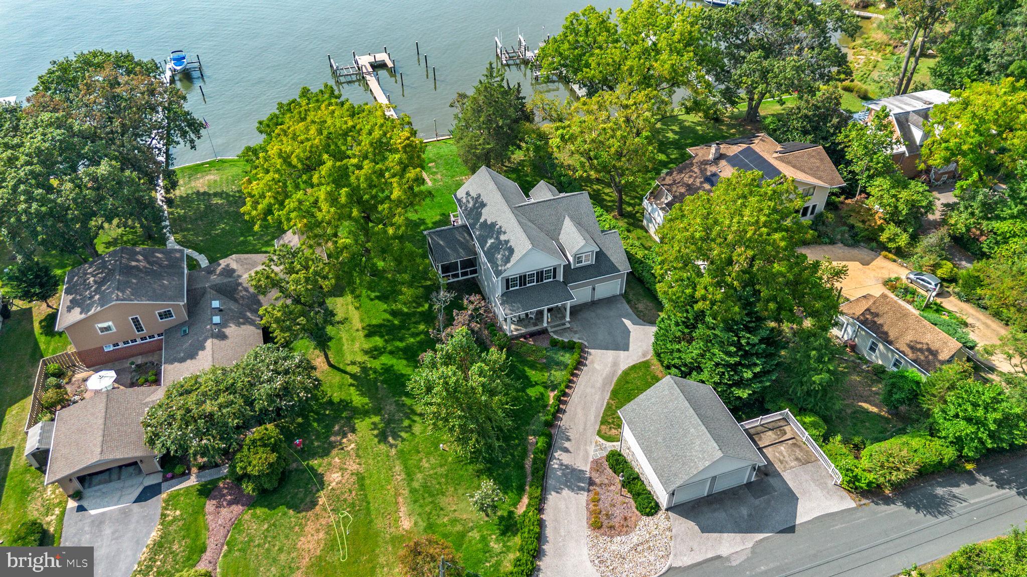 BREATHTAKING VIEWS, DEEP WATER, AND NEWLY BUILT HOME!!!!

Situated along the scenic shores of the Magothy River, this exceptional property offers a rare blend of privacy, functionality, and premier waterfront living.  Newly built home which is just over ten years young with detached garage and massive workshop.  Set on Long Cove with 100 feet of shoreline and desirable southern exposure, the home is perfectly positioned to capture abundant natural light and sweeping water views—delivering the very essence of life on the Chesapeake Bay.

Boating enthusiasts will immediately appreciate the thoughtfully designed private pier, extending 112 feet with a 90-foot section re-decked in 2018 and a 2017 extension of 22-foot featuring a 24,000 lb boat lift (installed in 2017 and professionally maintained). Fully equipped with both 240V and 110V power and offering water depths of approximately 5 to 8 feet at the boat lift.  This deep-water setting—complete with riparian rights—provides a 14 foot wide lift slip and a 20 foot wide wet slip that comfortably accommodates a variety of vessels and provides an exceptional launch point for days on the water.

Inside, the home spans three finished levels designed for both everyday comfort and flexible living. The main level is anchored by a spacious great room featuring soaring ceilings and panoramic water views.  There are 9 foot ceilings throughout the remainder of the main level which includes hardwood floors, custom cabinetry in the kitchen, pantry and primary bath and a cozy propane fireplace.  The great room is overlooked by a lofted upper space that enhances the home’s open and airy feel. A highly desirable main-level primary suite offers convenience and privacy, while additional bedrooms and baths provide space for family, guests, or a home office. The walkout lower level adds valuable living and storage space, complete with a propane stove, a full bath, and endless potential for recreation or customization.  The home includes many recent updates such as fresh paint exterior and interior, newly carpeted bedrooms and stairway, and new appliances (refrigerator, dishwasher, washer, dryer, water heater). Outdoor living is just as impressive, with a screened porch, deck, and multiple vantage points to take in the peaceful river and cove views. 

Whether you’re enjoying a quiet morning or entertaining guests, the setting is truly special, with effortless access to boating, fishing, and waterfront adventures right from your gently sloped backyard.
A standout feature is the detached two-story garage, offering two upper-level vehicle bays and a lower-level workshop—ideal for hobbyists, storage, or additional workspace. With a total of four garage bays and ample driveway parking, this property is as practical as it is picturesque. Located in a community with beach access, marina amenities, and a relaxed coastal lifestyle, this home presents a rare opportunity to enjoy the best of waterfront living with space, versatility, and timeless appeal. Schedule your private tour today!