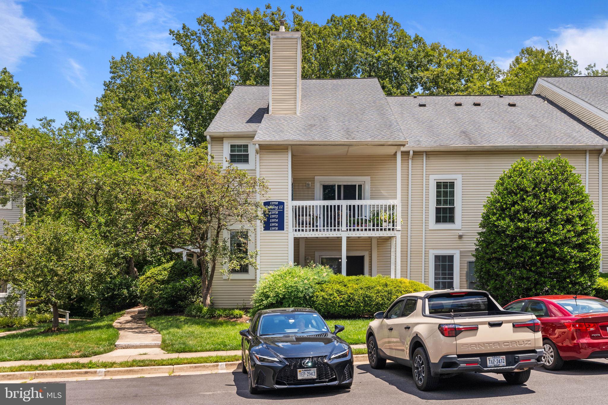 Discover the perfect blend of privacy and convenience in this beautifully updated condo, ideally located within the sought-after Vinings Condominium community in Lake Ridge. Freshly painted with hardwood flooring throughout, this inviting home offers a peaceful retreat surrounded by lush woodland views.
The open living and dining area features a cozy wood-burning . Step through the sliding glass door to a spacious covered balcony. 
The well-appointed kitchen offers abundant cabinet storage, generous counter space, and a gas range. The generous bedroom includes a double reach-in closet. The upgraded bath features a white shaker vanity with quartz-look countertop, arched mirror, and tub/shower combination. A dedicated laundry room with built-in shelving and full-size washer and dryer adds everyday convenience.
Enjoy a quiet cul-de-sac location with assigned parking. Residents have unparalleled access to Lake Ridge amenities including parks, nature trails, golf, marina, community center, and tennis and basketball courts. Abundant dining, shopping, and entertainment nearby with easy access to major commuter routes — ideal for busy professionals or first-time buyers.