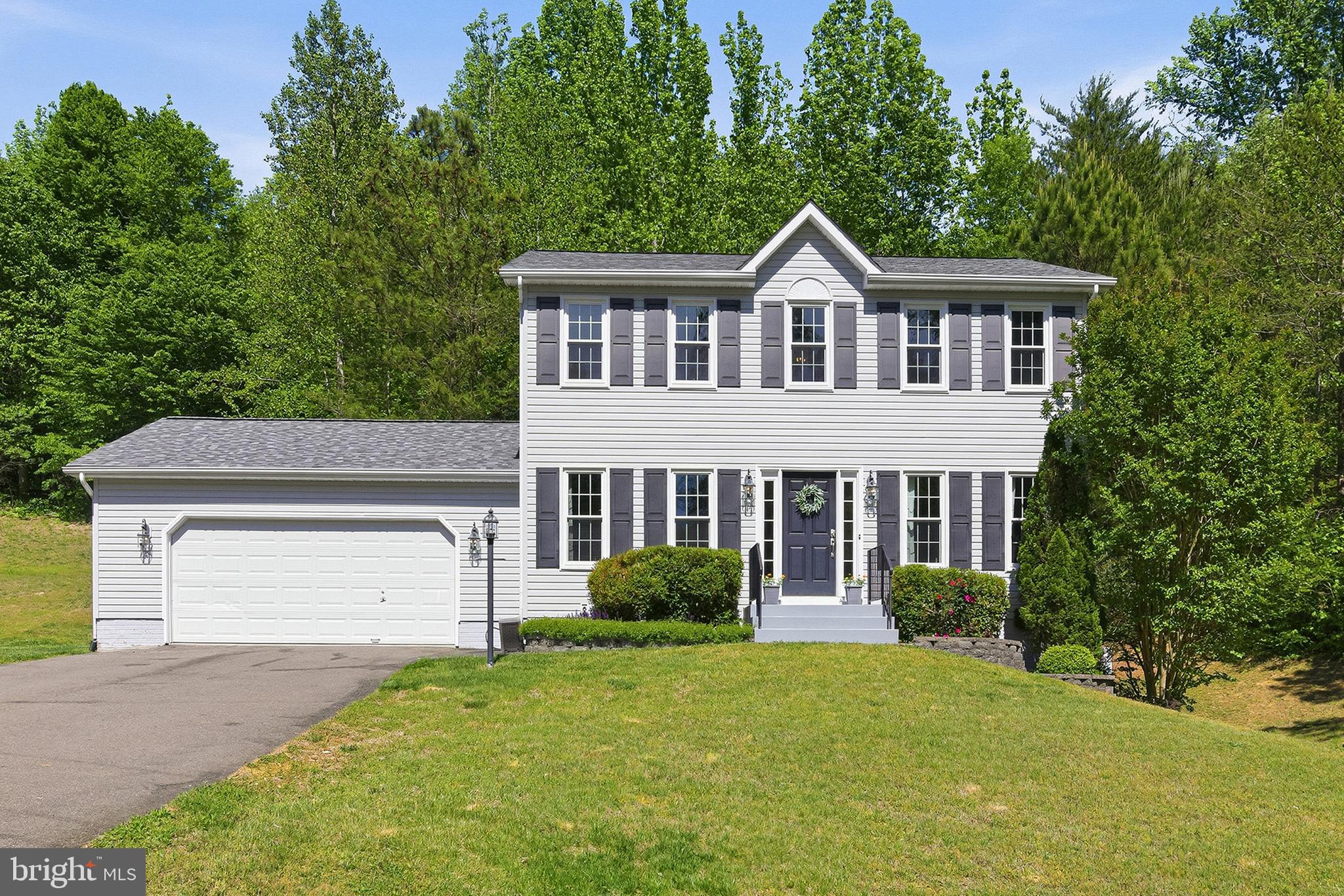 Welcome home to 8349 Reagan Drive! Nestled on a generous 0.68-acre lot in the Presidential Lakes community, this 4​BR/3.5BA ​Colonial combines style and comfort with an easy commute to Fredericksburg, NSWC Dahlgren, and Maryland. ​As you approach the front door, you'll appreciate the pride shown and care given to this home by the current owners. Inside on the main level, the living room, dining room, and den all center around a​n updated and clean kitchen with white cabinetry, stainless steel appliances, and a built-in bar that is ideal for entertaining. ​Desirable details like hardwood floors, wainscoting, chair railing, and a cozy fireplace add warmth ​throughout​. Upstairs, the upgraded ​​primary suite features a soaking tub, separate shower, dual vanities, and a walk-in closet.​ Two other bedrooms balance out the upper level with a hall bathroom. Downstairs, the newly finished walkout basement expands your living space with a 4th bedroom, ​a rec room, an office or additional flex space, a full bathroom, and durable luxury vinyl plank flooring. Outside, a ​new and inviting deck overlooks the spacious yard.​ You'll appreciate the style and touches throughout this wonderful home. We welcome you to take a look for yourself soon! Updates to highlight: new roof and front windows (2020), basement professionally finished (2021), new deck (2024), water heater (2025), refrigerator (2025)​, microwave (2026).