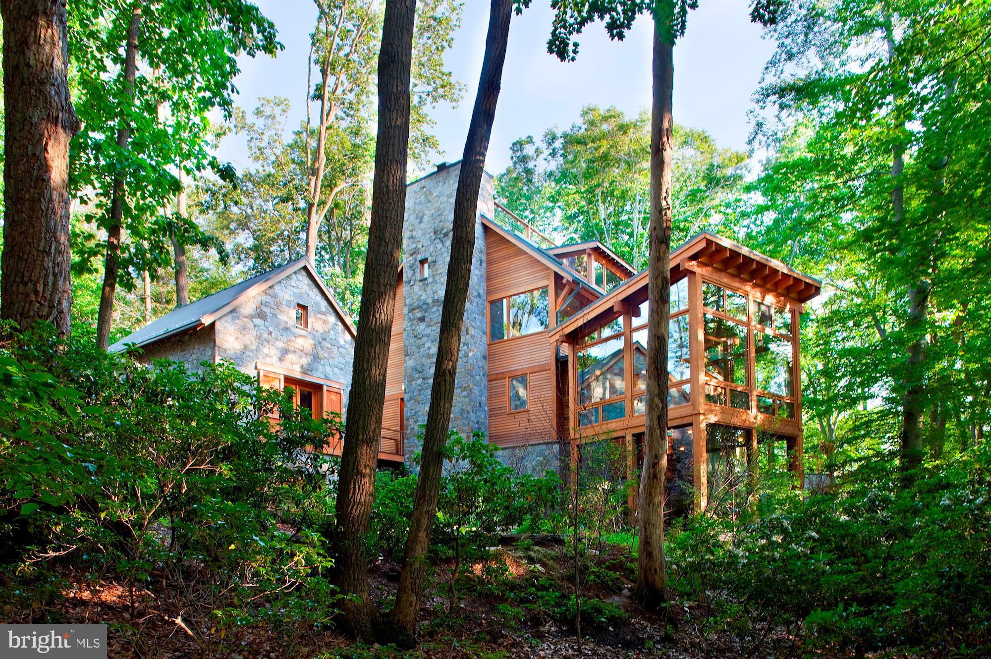 Nature lovers paradise! Exterior of cedar and stone nestled in the trees with Potomac River views! Every Room of the home allows you to experience the outdoors. Stream feeding into the Koi pond, porches and patio with spectacular views! Jim Rill Architect masterpiece with wide plank oak and flagstone flooring, exercise pool, elevator, generator, geothermal heating and cooling, artist's studio, three fireplaces. The home is in the Merry Go Round Farm Community that has two barns, an equestrian center for horse boarding and riding lessons, miles of hiking and riding trails, on site groundskeepers and barn hands, and lighted tennis courts.