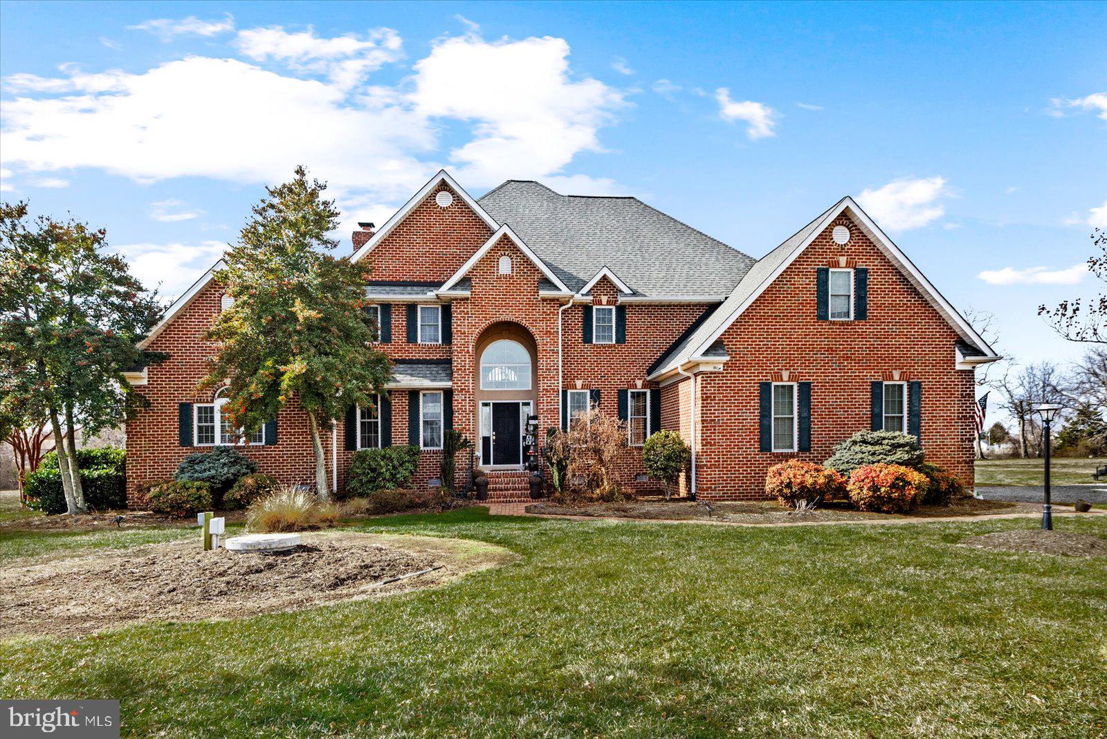 Wellcome Home! Waterfront Luxury Living at 257 Church Point Lane, Colonial Beach, VA 22443.
Experience unparalleled elegance in this custom-built brick home situated on a serene 2.93-acre waterfront lot in the prestigious Church Point community of historic Westmoreland County. This expansive residence offers 3,850 square feet of meticulously designed living space, featuring 4 bedrooms and 3.5 bathrooms. The open-concept floor plan seamlessly connects the living, dining, and kitchen areas, creating an ideal space for both relaxation and entertaining.  A chef's dream, the kitchen is equipped with high-end appliances, custom cabinetry, and ample counter space. The main level master bedroom offers stunning  views, two generous walk-in closets, and a spa-like en-suite bathroom with dual sinks, a soaking tub, and a separate shower. Step outside to a private patio and a separate screened in porch that leads to the tranquil lake, perfect for boating, fishing, or simply enjoying the natural beauty. The home includes a two-car garage, whole home generator, central air conditioning, and an in-unit laundry room for added convenience. Church Point is a sought-after community known for its peaceful ambiance and proximity to local attractions. Residents enjoy easy access to Colonial Beach's shops, dining, and recreational activities, all while being nestled in a tranquil, nature-filled environment.