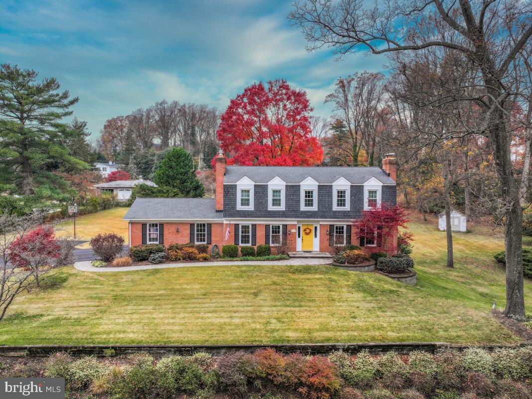 Nestled in the coveted and sought-after water-privileged neighborhood of Rugby Hall Estates along the Severn River, this timeless Dutch Colonial blends traditional design with warm, inviting spaces throughout. Offering four bedrooms, all with hardwood flooring and two-and-a-half baths, the home features a gracious living room anchored by a classic brick wood-burning fireplace with a custom mantel and rich hardwood floors that flow throughout most of the main level. The kitchen is thoughtfully designed with granite countertops, tile flooring, solid cherry cabinets, built-ins, a sunny eat-in area, soft close drawers, pull out shelving and a lighted cabinet for specialty items. A stunning Florida room showcases a wood ceiling and heated floors, creating a cozy year-round retreat, while a spacious deck steps down to a beautifully manicured yard with mature landscaping. A main-level office with propane fireplace provides the ideal work-from-home setting. Upstairs, the primary suite offers a private escape with its own wood-burning fireplace, dressing area, and walk-in closet. The walk-out lower level expands the living space with a recreation room featuring a brick wall fireplace with wood stove—perfect for gatherings with easy access to the outdoors. The professionally landscaped front yard features an inground sprinkler system and exterior lighting.  A very efficient Geo-Thermal heating and A/C system keeps energy costs low. You will enjoy exceptional community amenities including a dock, waterfront playground, and pavilion, embracing the best of Severn River living.