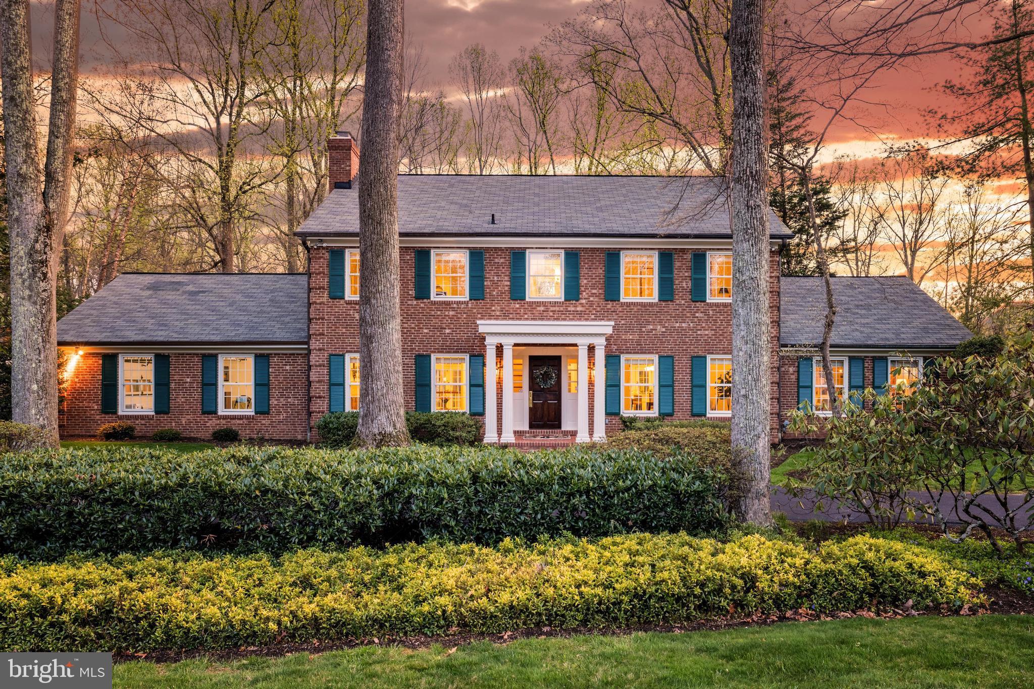 Deadline 4pm Monday. Be totally surprised by this stylish brick Colonial that transforms into a stunning space the minute you step into a gracious 30-ft-long entry. If you love architectural craftsmanship and luxury designer updates, RUN don’t walk, because this is a one-of-a-kind renovated home with a gorgeous pool and distinctive guest house that feels like a retreat in an epic natural setting. The yard backs to acres of protected land and feels even larger than its one-plus acre lot. A beloved family compound for 25 years, the residence offers $400K+ in new upgrades and an appealing circular floor plan that offers privacy when you need it. A perfectly scaled home that feels like a giant hug, you’ll love the classy moldings, pretty sunroom and the fabulous kitchen created by the design rock stars at Unique Kitchens and Baths (UKB). The remarkable back addition has walls of windows, soaring ceilings, a breathtaking Jeffersonian inspired curved dining atrium, and an impressive Palladian-window office with a 13-foot stone fireplace.
This home is perfect for entertaining or relaxation in your own “country oasis.” The scenic property is bursting with seasonal blooms and features an expansive patio, a poolside white picket fence and bluestone garden paths. The guest house is beautifully designed and has a copper roof and semi wrap-around covered porch. 
Celebrity designer Tanya Smith-Shiflett, founder of Unique Kitchen and Baths, created the kitchen which was built by Carrmichael Construction. The English inspired space features custom flush-inset cabinetry, quartz countertops, designer lighting and tile, European faucets and cabinet pulls and high-end appliances. The kitchen has a 96-inch island, breakfast room and a tall limed-oak hutch designed by Lauren Liess.
Another dining space sits off the family room and kitchen. The oversized family room opens to the sunroom thru French doors with antique hardware. It has coveted tongue and groove walls, parquet floors, a beamed ceiling, a built-in desk and cabinets and a floor-to-ceiling brick gas fireplace. 
Completing the spacious first floor is a full bath with gorgeous artisan floor tile, a 30-foot living room with a wood fireplace and a big mudroom with skylights and custom cabinetry.
The second floor has a wide hallway and four large, bright bedrooms. The newly renovated primary bath is exquisite with beautiful Carrara marble countertops and a Carrara mosaic tiled floor along with a double sink vanity, a custom glass door, designer sconces and a classic marble slab shower. The primary suite features a dressing area and two walk-in closets. The new hall bath has handcrafted subway tiled walls, an eye catching black and white vintage tiled floor and a new marble-topped vanity.
The spacious recreation room gets natural light from a lovely open staircase and has a brick fireplace and a den that could be an ideal au pair suite with its big closet and built ins. It adjoins an updated full bath and the laundry-storge room. The lower level, mudroom, and guest house have new luxury vinyl floors.
The pool is a showstopper renovated in 2023 with a brick edge coping, pretty tile, and a diving board. The guest house is the perfect getaway for visitors and has a large bedroom with a picturesque bay window, a full bath and sitting room kitchenette that has a fun window that opens to the outside serving bar. The charming porch has a striking beamed wood ceiling and offers great woodland views. The unique third garage overlooks the pool and features a French door window design that mimics the curved dining atrium and could be adopted for other living uses. 
This exceptional property offers traditional modern living, unparalleled natural beauty, privacy and a fantastic location minute to Tysons Corner, the Metro, airports and two national parks - Great Falls and Wolf Trap. This home is in the esteemed Spring Hill/Langley high school pyramid.
Heat & Hot Water is Electric in Guest House.