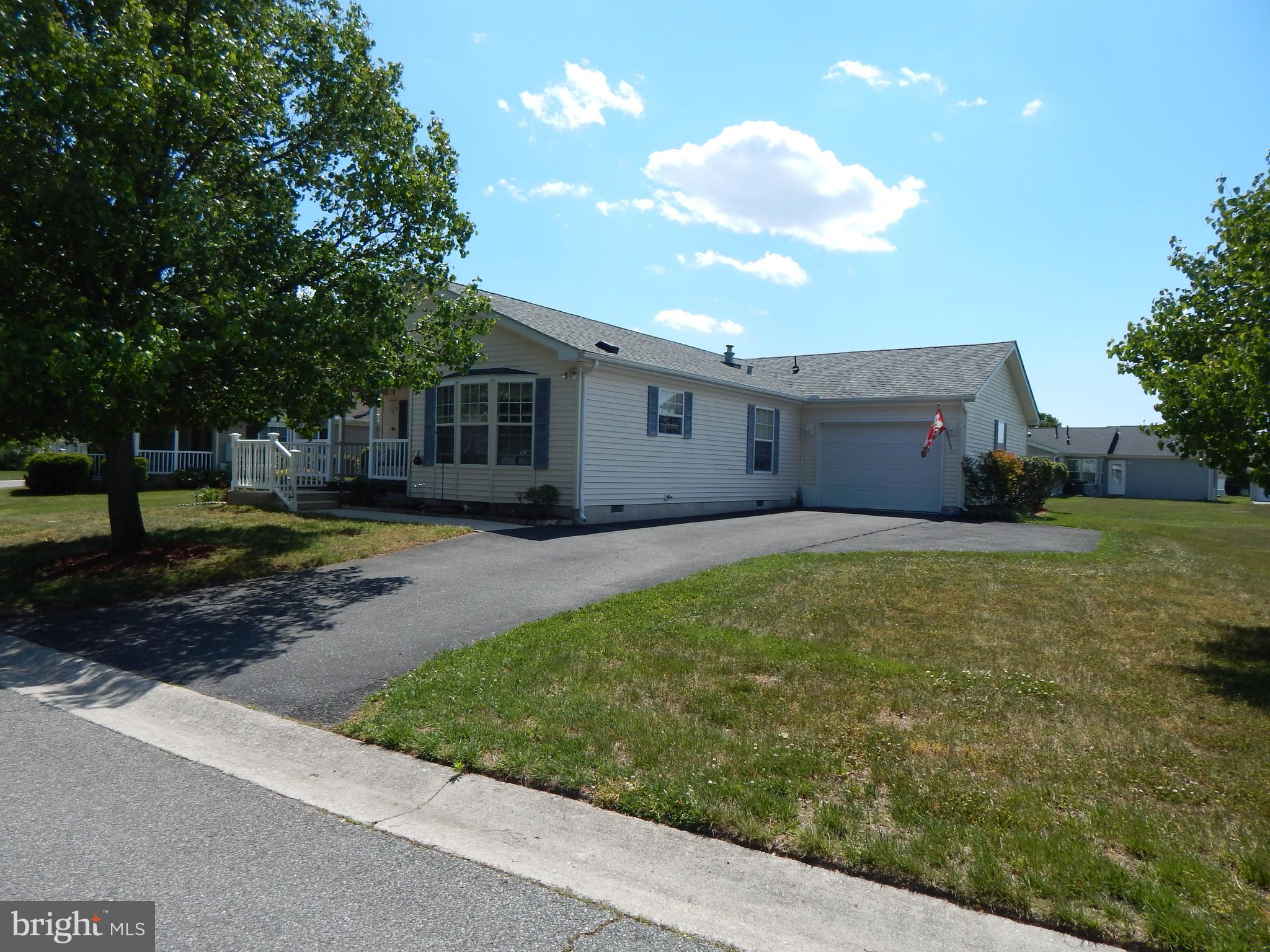 Sharp and tidy 2 Bedroom / 2 Full bath home in the Senior community of Wild Meadows with attached garage with extra wide driveway space for ample parking for friends and family. Extra room with side entrance for a den, office or craft / hoobies. Lot rent includes freedom from lawn care and full access to community amenities: clubhouse, heated pool, hot tub, fitness center, , bocce, horseshoes,  or safe exercise walks around the over 55 neighborhood. Buyer must be approved by Wild Meadows / RHP Landowner.