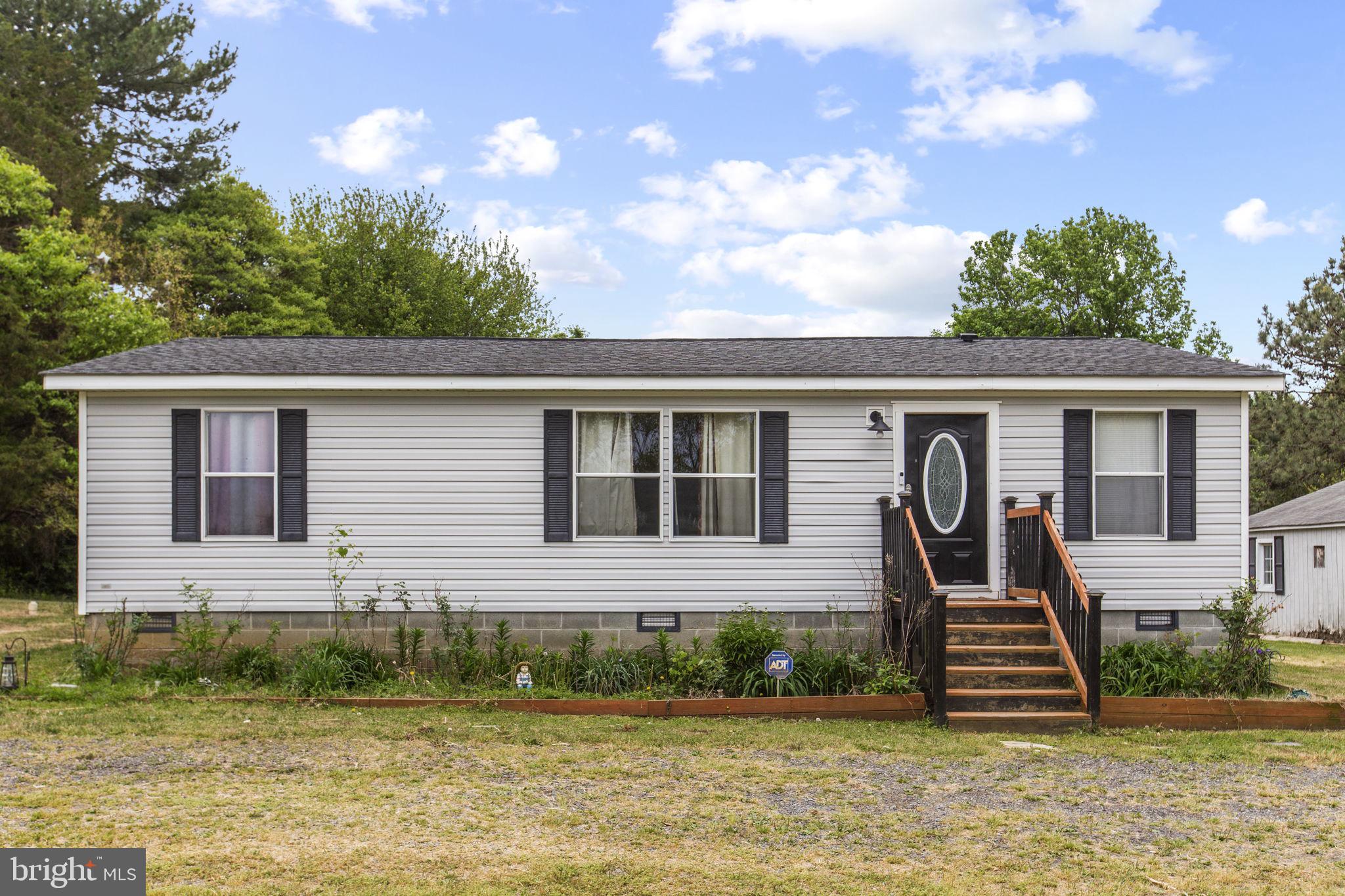 Double wide manufactured home featuring 3 beds and 2 baths, offering 1,080 sq ft on a spacious 0.74
acre lot. The kitchen features wooden cabinets, stainless steel appliances, and tile flooring. Living area
includes a fireplace and wood flooring. Main bedroom offers carpet flooring with open cabinets, while two
additional bedrooms have open storage and LVT flooring. Bathroom includes a wooden under-sink
cabinet, granite countertop, tile flooring, and a bathtub. Dedicated laundry area adds convenience.
Detached 2-car garage provides ample parking and storage. The large yard offers plenty of space for
outdoor living and entertaining, featuring a playground-style setup with an outdoor bar pavilion, tot slide, swing, and an above-ground pool, while still leaving room for gatherings or future improvements.