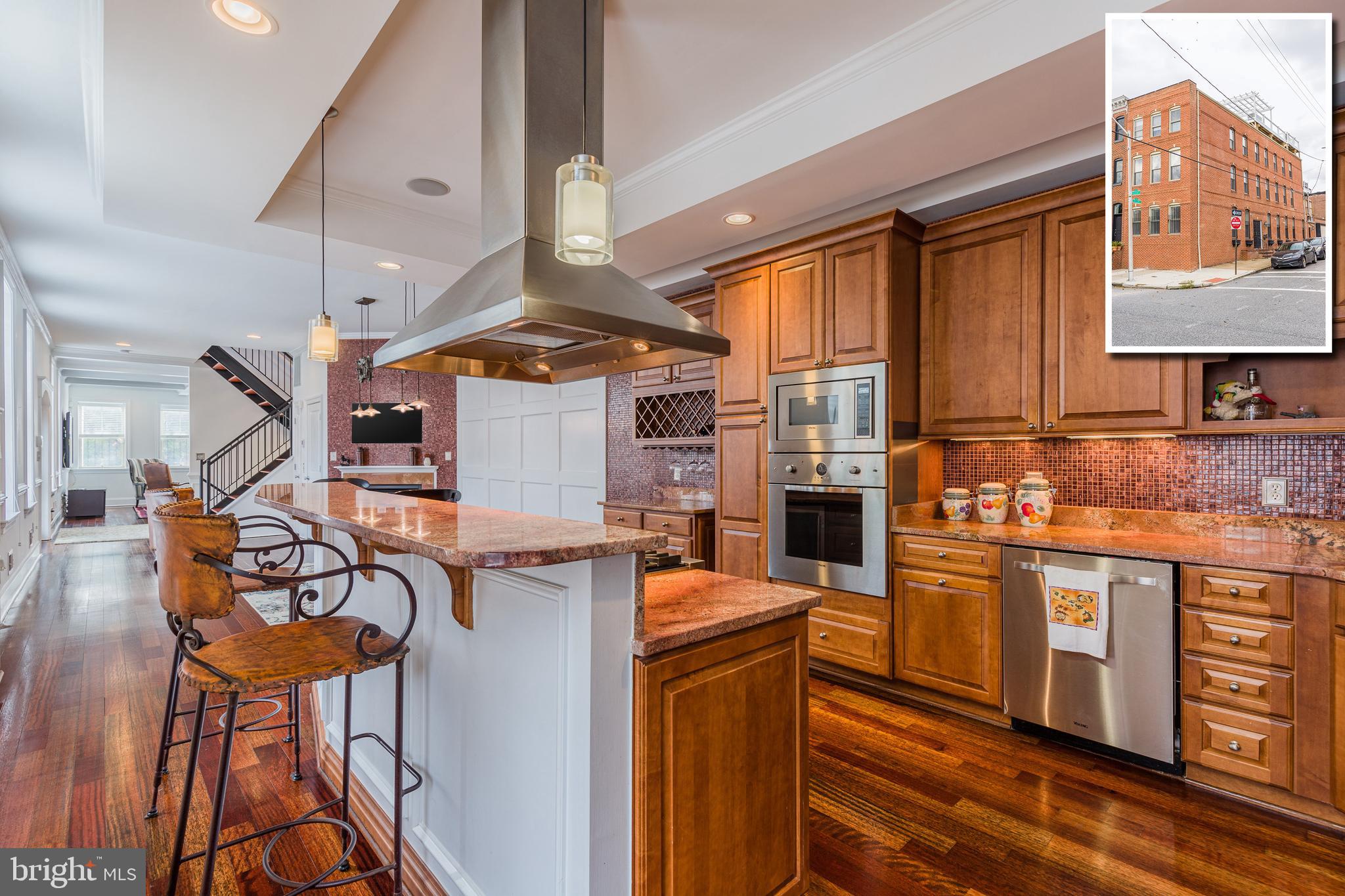 CONTEMPORARY ELEGANCE RADIATES THROUGHOUT THIS EXPANSIVE 4,000+ SQ. FT. GARAGE ROWHOME IN PRIME CANTON LOCATION!  This one has it all!  Elevator to all 4 levels, whole house speaker system, gleaming hardwood floors throughout the main and upper levels, large room sizes, gourmet island kitchen w/ high end ss appliances, and granite counters.  The 2nd level offers 2 large bedrooms and 2 full baths, bedroom level laundry, and rear deck with a privacy fence.  The  incredible Master suite encompasses the entire 3rd level and features a walk-in closet w/ built-ins, sitting area w/ a wet bar, and luxury spa bath w/ whirlpool tub, and walk-in shower w/ multiple shower heads.  There is plenty of room to entertain with 3 levels of outdoor living space including a tiered rooftop deck w/ Pergola and impressive views.  Parking is not an issue with the attached 2 car garage.  All of this and located in the heart of Canton - this is city living at it's best!
