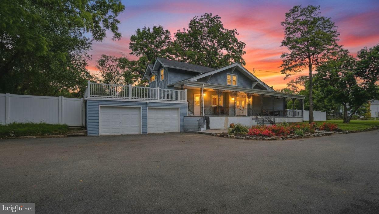 Stunningly renovated and expanded home offering over 3,000 sq ft of finished living space on a huge 1/2+ acre lot! Completely transformed in 2020 with major updates including roof, HVAC, driveway, and beautifully redesigned interior spaces. This is truly one of those homes you must experience in person to fully appreciate the incredible size, layout, and warmth it offers.

Enter through double front doors into a dramatic foyer with chandelier, opening to a formal living room (or use as dining room - it is large enough to accommodate an 8+ person table.) Beyond this bonus room is an impressive GREAT room featuring a brick fireplace and exceptional space for entertaining, relaxing, or hosting large gatherings.

The modern kitchen has white 42” cabinetry, quartz countertops, soft-close drawers and cabinets, stainless steel appliances, double oven, wine fridge, designer tile backsplash, and breakfast area. Gorgeous hardwood flooring extends throughout most of the main level.

The main-level primary suite truly feels like a private retreat, offering a sitting area, coffered ceilings, recessed lighting, oversized walk-in closet, and spa-inspired bath featuring double quartz vanity, walk-in tile shower, and 2 person soaking tub.

Upper level offers spacious secondary bedrooms with walk-in closets plus an additional bedroom ideal for nursery, office, or study. Home features 4 full bathrooms, including baths on the main level, upper level, lower level, and private primary suite bath.

Finished lower level has stylish ceramic tile flooring, laundry room, full bath, and access to oversized attached 2-car garage.

Outdoor spaces are equally impressive with a covered front porch spanning the length of the home, an enormous roof deck over the garage, expansive yard, and extra-long asphalt driveway with abundant parking — ideal for entertaining, multi-vehicle households, or home-based business needs.

Conveniently located near shopping, dining, Metro access, and major commuter routes. A rare combination of space, updates, functionality, and character!

This home is eligible for the MMCT (majority minority census tract) program. Please discuss with your loan officer! Program highlights are:  No PMI - $5,000 grant - 620+ credit score - NOT limited to first-time buyers
