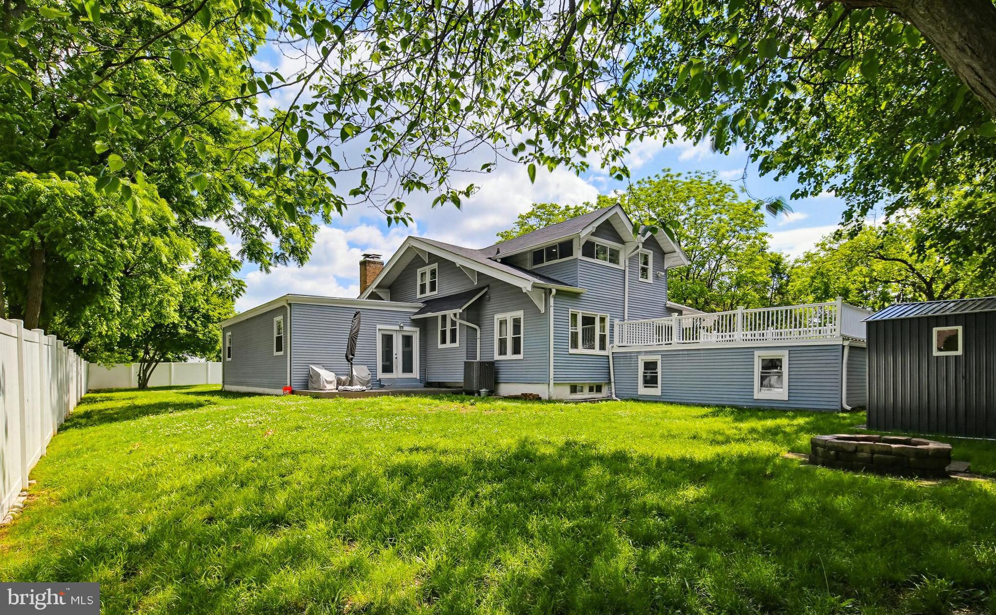 Stunningly renovated and expanded home offering over 3,000 sq ft of finished living space on a huge 1/2+ acre lot! Completely transformed in 2020 with major updates including roof, HVAC, driveway, and beautifully redesigned interior spaces. This is truly one of those homes you must experience in person to fully appreciate the incredible size, layout, and warmth it offers.

Enter through double front doors into a dramatic foyer with chandelier, opening to a formal living room (or use as dining room - it is large enough to accommodate an 8+ person table.) Beyond this bonus room is an impressive GREAT room featuring a brick fireplace and exceptional space for entertaining, relaxing, or hosting large gatherings.

The modern kitchen has white 42” cabinetry, quartz countertops, soft-close drawers and cabinets, stainless steel appliances, double oven, wine fridge, designer tile backsplash, and breakfast area. Gorgeous hardwood flooring extends throughout most of the main level.

The main-level primary suite truly feels like a private retreat, offering a sitting area, coffered ceilings, recessed lighting, oversized walk-in closet, and spa-inspired bath featuring double quartz vanity, walk-in tile shower, and 2 person soaking tub.

Upper level offers spacious secondary bedrooms with walk-in closets plus an additional bedroom ideal for nursery, office, or study. Home features 4 full bathrooms, including baths on the main level, upper level, lower level, and private primary suite bath.

Finished lower level has stylish ceramic tile flooring, laundry room, full bath, and access to oversized attached 2-car garage.

Outdoor spaces are equally impressive with a covered front porch spanning the length of the home, an enormous roof deck over the garage, expansive yard, and extra-long asphalt driveway with abundant parking — ideal for entertaining, multi-vehicle households, or home-based business needs.

Conveniently located near shopping, dining, Metro access, and major commuter routes. A rare combination of space, updates, functionality, and character!

This home is eligible for the MMCT (majority minority census tract) program. Please discuss with your loan officer! Program highlights are:  No PMI - $5,000 grant - 620+ credit score - NOT limited to first-time buyers