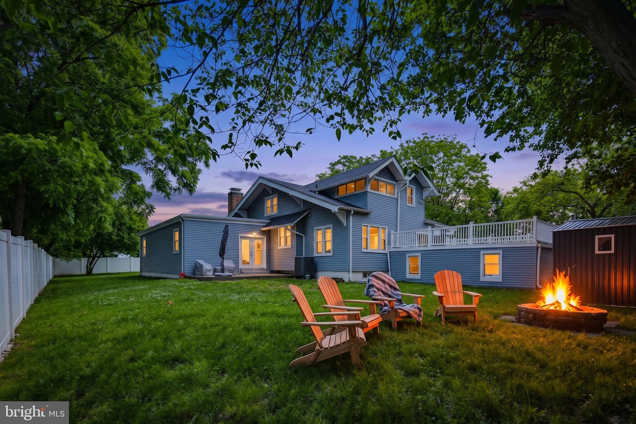 Stunningly renovated and expanded home offering over 3,000 sq ft of finished living space on a huge 1/2+ acre lot! Completely transformed in 2020 with major updates including roof, HVAC, driveway, and beautifully redesigned interior spaces. This is truly one of those homes you must experience in person to fully appreciate the incredible size, layout, and warmth it offers.

Enter through double front doors into a dramatic foyer with chandelier, opening to a formal living room (or use as dining room - it is large enough to accommodate an 8+ person table.) Beyond this bonus room is an impressive GREAT room featuring a brick fireplace and exceptional space for entertaining, relaxing, or hosting large gatherings.

The modern kitchen has white 42” cabinetry, quartz countertops, soft-close drawers and cabinets, stainless steel appliances, double oven, wine fridge, designer tile backsplash, and breakfast area. Gorgeous hardwood flooring extends throughout most of the main level.

The main-level primary suite truly feels like a private retreat, offering a sitting area, coffered ceilings, recessed lighting, oversized walk-in closet, and spa-inspired bath featuring double quartz vanity, walk-in tile shower, and 2 person soaking tub.

Upper level offers spacious secondary bedrooms with walk-in closets plus an additional bedroom ideal for nursery, office, or study. Home features 4 full bathrooms, including baths on the main level, upper level, lower level, and private primary suite bath.

Finished lower level has stylish ceramic tile flooring, laundry room, full bath, and access to oversized attached 2-car garage.

Outdoor spaces are equally impressive with a covered front porch spanning the length of the home, an enormous roof deck over the garage, expansive yard, and extra-long asphalt driveway with abundant parking — ideal for entertaining, multi-vehicle households, or home-based business needs.

Conveniently located near shopping, dining, Metro access, and major commuter routes. A rare combination of space, updates, functionality, and character!

This home is eligible for the MMCT (majority minority census tract) program. Please discuss with your loan officer! Program highlights are:  No PMI - $5,000 grant - 620+ credit score - NOT limited to first-time buyers