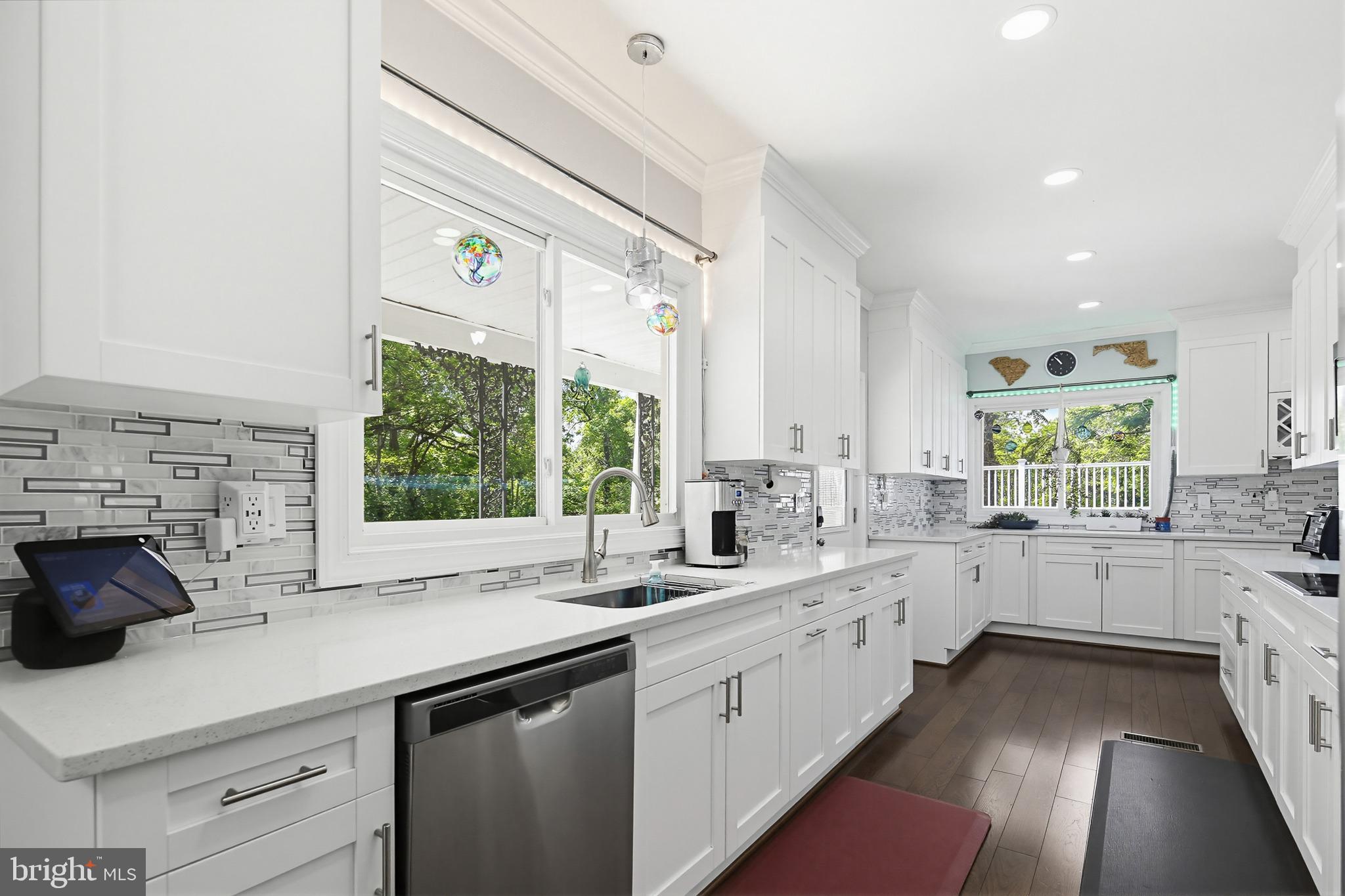 OPEN SATURDAY, June 20th form 1-3pm! 
Renovated and expanded SMART home offering over 3,000 sq ft of finished living space on a huge 1/2+ acre lot! Completely transformed in 2020 with a new roof, HVAC, driveway, integrated smart-home technology, and beautifully redesigned interior spaces. This is truly one of those homes you must experience in person to appreciate.

Enter through double front doors into a dramatic foyer with chandelier, opening to a formal living room or dining room large enough for an 8+ person table. Beyond is an impressive GREAT room with brick fireplace and exceptional space for entertaining.

The modern kitchen features white 42" cabinetry, quartz countertops, soft-close drawers and cabinets, stainless steel appliances, double oven, wine fridge, designer tile backsplash, and breakfast area. Gorgeous hardwood flooring extends throughout most of the main level.

The main-level primary suite feels like a private retreat with a sitting area, coffered ceilings, oversized walk-in closet, and spa-inspired bath featuring a double vanity, walk-in tile shower, and two-person soaking tub.

Upstairs offers spacious secondary bedrooms with walk-in closets and an additional bedroom perfect for a nursery, home office, or study. The home features 4 full bathrooms and a finished lower level with ceramic tile flooring, full bath, laundry room, and access to the oversized attached 2-car garage.

Enjoy a covered front porch, enormous rooftop deck, huge yard, and extra-long driveway with abundant parking for multiple vehicles.

Conveniently located near Metro access, Washington DC, Northern Virginia, shopping, dining, and major commuter routes. A rare combination of space, updates, smart-home convenience, and character!

Eligible for the MMCT program: No PMI, $5,000 grant, 620+ credit score, and not limited to first-time buyers. Please consult your lender for details.