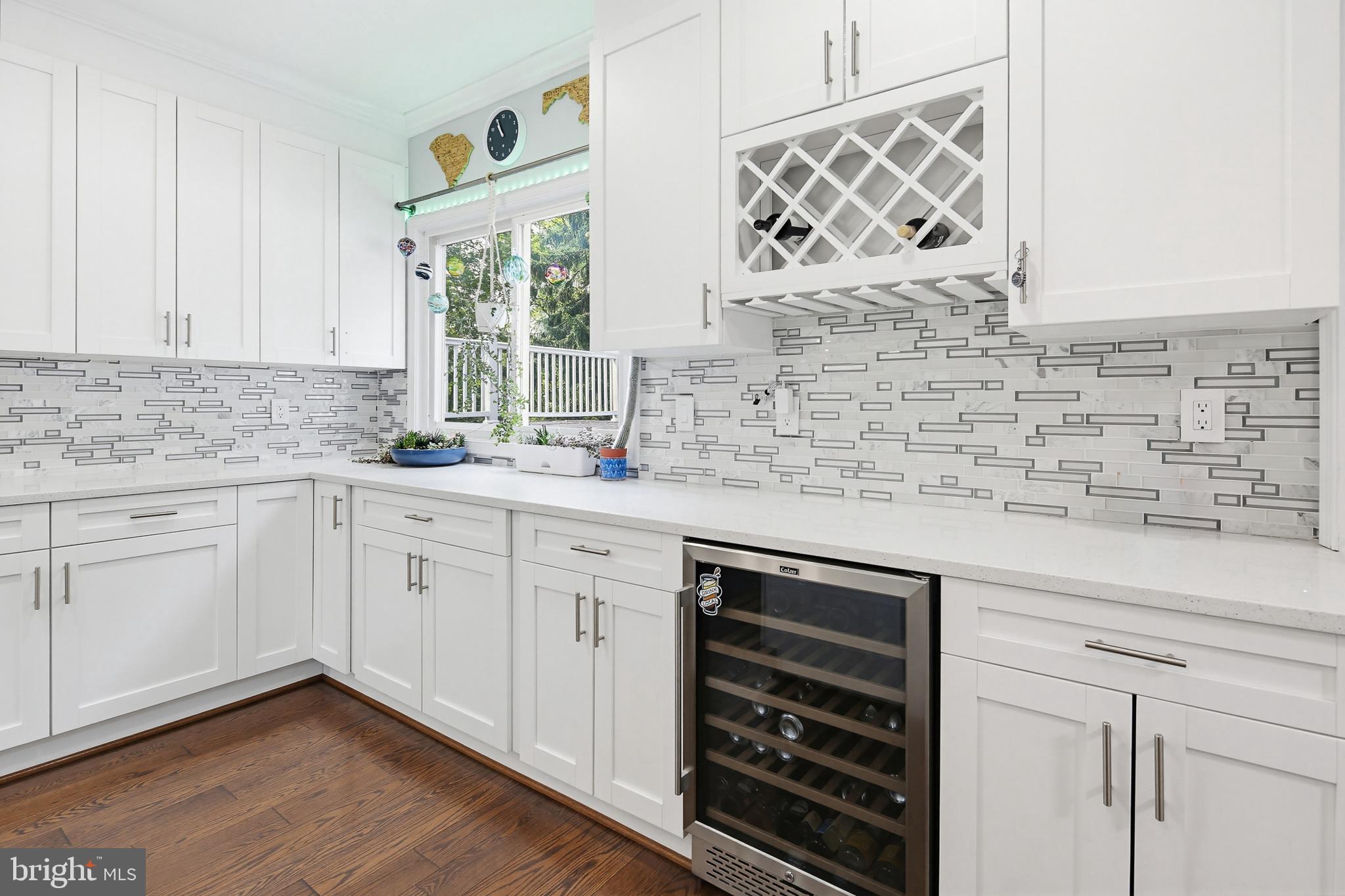 OPEN SATURDAY, June 20th form 1-3pm! 
Renovated and expanded SMART home offering over 3,000 sq ft of finished living space on a huge 1/2+ acre lot! Completely transformed in 2020 with a new roof, HVAC, driveway, integrated smart-home technology, and beautifully redesigned interior spaces. This is truly one of those homes you must experience in person to appreciate.

Enter through double front doors into a dramatic foyer with chandelier, opening to a formal living room or dining room large enough for an 8+ person table. Beyond is an impressive GREAT room with brick fireplace and exceptional space for entertaining.

The modern kitchen features white 42" cabinetry, quartz countertops, soft-close drawers and cabinets, stainless steel appliances, double oven, wine fridge, designer tile backsplash, and breakfast area. Gorgeous hardwood flooring extends throughout most of the main level.

The main-level primary suite feels like a private retreat with a sitting area, coffered ceilings, oversized walk-in closet, and spa-inspired bath featuring a double vanity, walk-in tile shower, and two-person soaking tub.

Upstairs offers spacious secondary bedrooms with walk-in closets and an additional bedroom perfect for a nursery, home office, or study. The home features 4 full bathrooms and a finished lower level with ceramic tile flooring, full bath, laundry room, and access to the oversized attached 2-car garage.

Enjoy a covered front porch, enormous rooftop deck, huge yard, and extra-long driveway with abundant parking for multiple vehicles.

Conveniently located near Metro access, Washington DC, Northern Virginia, shopping, dining, and major commuter routes. A rare combination of space, updates, smart-home convenience, and character!

Eligible for the MMCT program: No PMI, $5,000 grant, 620+ credit score, and not limited to first-time buyers. Please consult your lender for details.