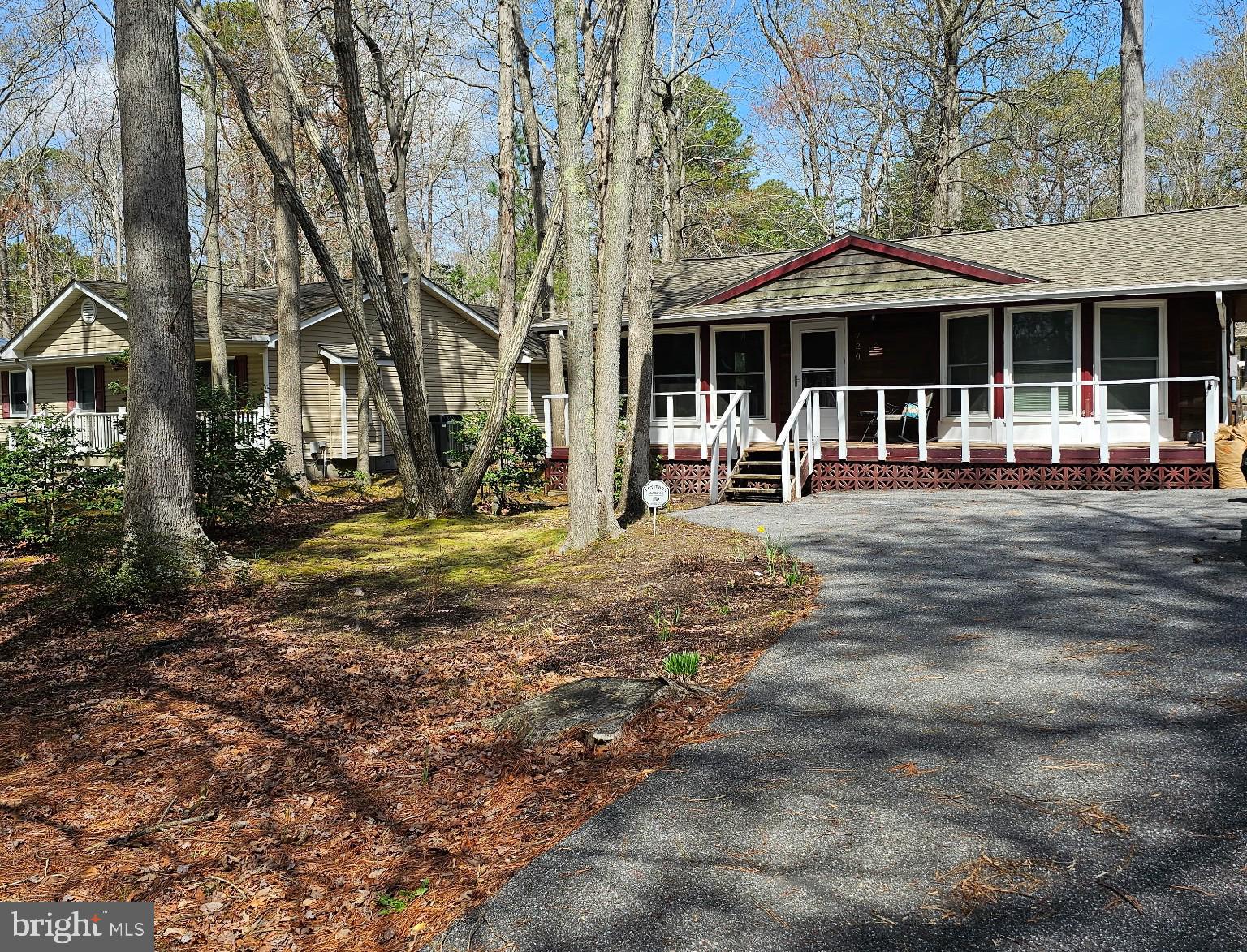 This charming ranch-style cottage offers a cozy get-away retreat. Inside, enjoy an open floor plan that connects the kitchen, dining area and the living room which boasts a wood-burning fireplace, ideal for cozy evenings. The bedrooms feature a tub plus walk-in shower.  Step outside to discover a very private quaint back patio and or front porch, perfect for morning coffee or evening relaxation.  You can also enjoy the community amenities include a pool, beach club, and recreational facilities.   A few important items: Architectural roof 2024 (warranty transferrable), Pella Windows 2020, Cortex ProPlus flooring 2020.  Don't miss the chance to make this delightful property your own!