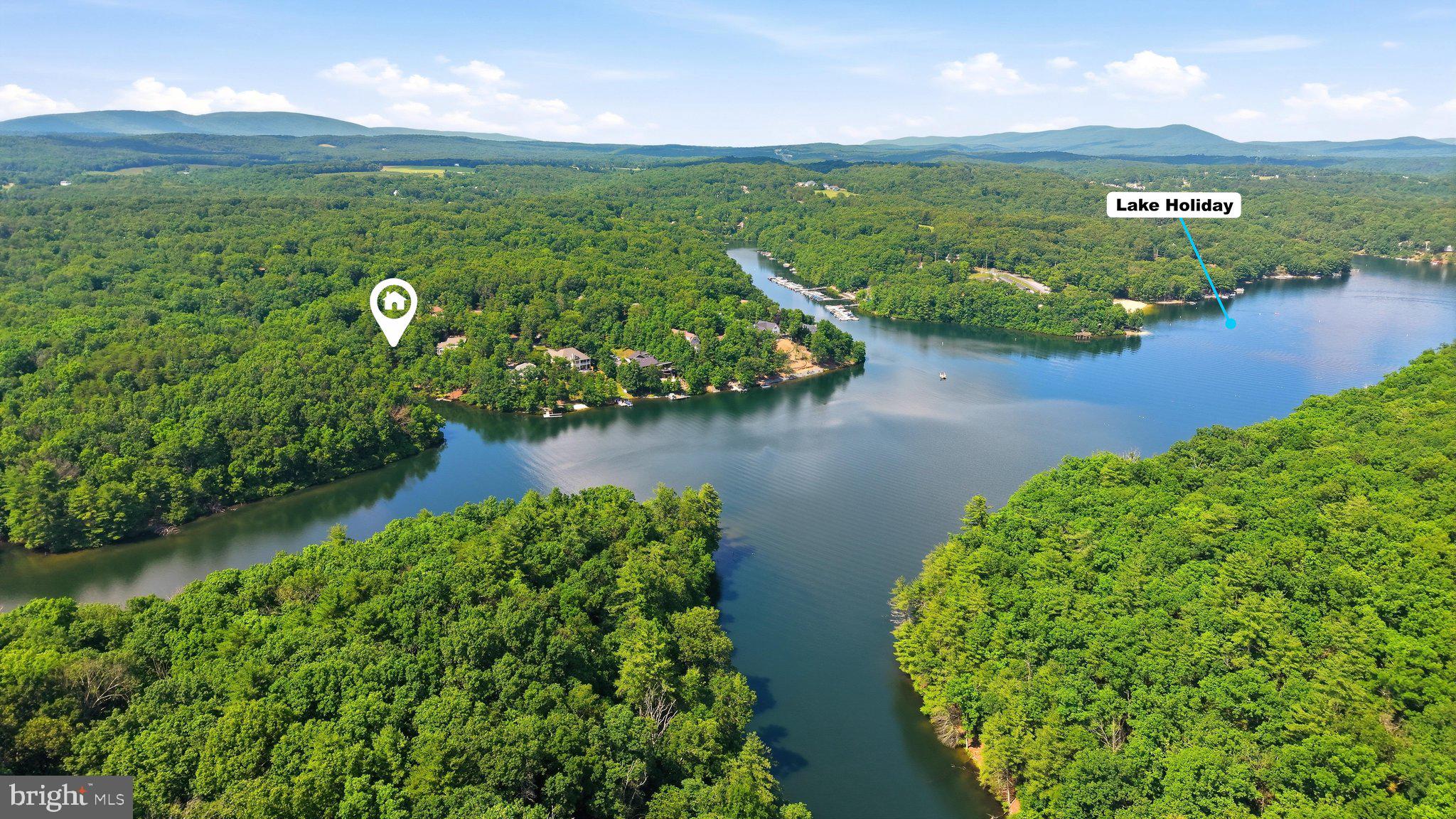 Build your dream waterfront home on this exceptional Lake Holiday lot! This buildable waterfront homesite offers the perfect setting to enjoy everything lake life has to offer.

A brand-new marine-grade dock has already been completed using premium TimberTech by AZEK decking in the beautiful French White Oak finish, providing immediate access to the water while saving you the time and expense of building one yourself. The dock and steps are already in place and can easily be repositioned slightly closer to the mouth of the inlet once construction begins. The sellers intentionally waited to move the dock into its final position until foundation excavation, allowing the tree currently in the water to be removed at the same time as the trees cleared for the home's construction.

The lot has already been surveyed, and a custom home has been thoughtfully designed to fit the property. To help bring your vision to life, the seller is willing to share the preliminary architectural drawings along with a rendering of the proposed home, giving the future owner an incredible head start on the building process.

Perfectly positioned on a peaceful cove with easy access to the main body of the lake, you'll enjoy the best of both worlds—calm, protected waters ideal for swimming, kayaking, paddleboarding, and fishing, along with quick access to open water for boating, tubing, wakeboarding, and all your favorite lake adventures.

Whether you're planning a year-round residence or the ultimate weekend getaway, this rare waterfront lot is ready for your vision. Located within the gated Lake Holiday community, you'll enjoy an outstanding lifestyle with amenities that include a 240-acre lake, sandy beaches, marina, clubhouse, swimming pools, tennis and basketball courts, playgrounds, hiking trails, and numerous community events throughout the year.

Don't miss this rare opportunity to create your own waterfront paradise in one of the Shenandoah Valley's most sought-after lake communities!