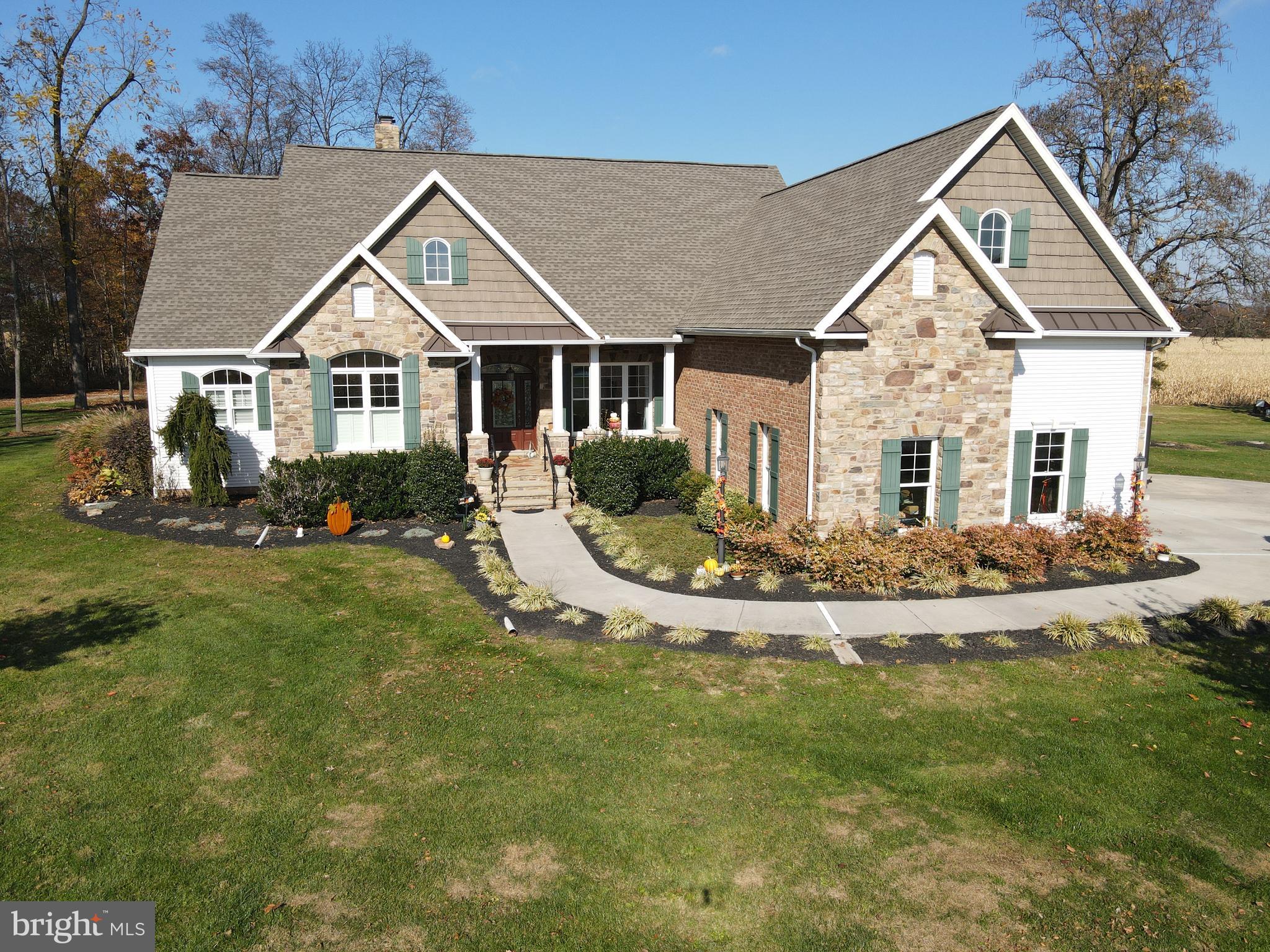 This property will be offered at Public Auction on Saturday, March 21, 2026 @ 12pm.  The listing price is the opening bid only and in no way reflects the final sale price.  $125,000 down due at auction, 2% transfer tax to be paid by the purchaser, real estate taxes prorated. This picturesque property is truly vacation-destination worthy and an opportunity you won’t want to miss! Spanning over 78 acres of farmland, woodlands, and open spaces, it features a spectacular all-stone and brick four-bedroom, four-bathroom home, just 20 minutes from historic Gettysburg. The custom home welcomes you with a formal entryway and continues with a formal dining room with a crystal chandelier. The kitchen boasts custom cabinetry by Dovetail Woodworks and a cozy breakfast nook, flowing into a sunroom with outdoor access, a full bathroom, and a family room with built-in bookcases by Dovetail Woodworks and a stone floor to ceiling fireplace. The main level also includes a bedroom currently used as an office & two master suites—each with two closets and a full bathroom, one of which features custom cabinetry from Dovetail Woodworks—plus a screened-in porch & laundry room. Upstairs, you will find a fourth bedroom along with a full bathroom and a large storage area. The full basement is unfinished and features high ceilings, offering the potential to create an additional 2,500 sq. ft. of finished living space. Beautiful oak floors from the property run throughout the main level, while wide-plank pine floors from the barn extend across the second floor, complemented by oak doors and poplar trim, as well as 9-foot ceilings throughout the home, cathedral ceilings in the family room and sunroom, and tray ceilings in one of the master bedrooms and the formal dining room. Outside, the property offers a half-acre pond stocked with bluegill, perch, and bass, with electricity nearby, a spacious two story bank barn, a large three bay pole building with a finished shop section, an outdoor fire pit area w/ storage surrounded by stone pillars and custom railing, and outdoor patio along with diverse wildlife and three deer stands. Currently, 60 acres of farmland are leased, and the woodlands were timbered approximately 15 years ago. Whether you’re looking for your next family home, a country retreat, or a private getaway, this property delivers it all!