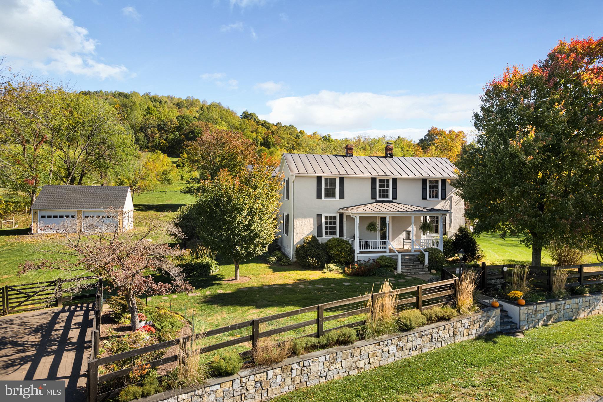 This charming historic Markham farmhouse rests quietly on 12.34 acres among neighboring local vineyards. Surrounded by mountains on 3 sides, this is the perfect primary residence or relaxing weekend retreat. Approximately 2 acres of developed land, 4 acres of pasture and 6 remaining acres of mixed forest and accompanying trails. 

It’s hard to miss this gorgeous country estate nestled along Leeds Manor Rd simply known by locals as "the one with the stone wall".  The stone wall evokes the character you expect to see throughout Hunt Country and it welcomes you home after a beautiful drive.

Built in 1909, this unique 4 bed/2 bath country cottage replicates English charm with modern amenities including: Pella windows, forced-air furnace and updated appliances. With hardwood floors throughout and a stunning Jøtul wood stove, winters are celebrated along with western-facing mountain views and stunning sunsets. The well-designed, main floor kitchen, full baths up and down, plumbing/electrical and new metal roof added back in 1995. Formal dining room and generous living spaces are easily enjoyed privately or during large holiday gatherings with friends and family. Alternative bedroom on main floor with full bath nearby. Escape with a book and cup of tea on your covered, front porch to feel right at home while enjoying your private, rural oasis.

Upstairs is a spacious foyer welcoming you to 3 gracious bedrooms, a single full-bath and laundry conveniently located within the main bedroom. A sun-lit morning fills the cathedral ceilings of the main bedroom built in 1995.  You’ll enjoy the warmth and security of your second-floor south-facing deck which offers tremendous privacy. Again, relax with a hot drink or simply admire the views and warm southern sun. With the feeling of Napa or Sonoma Valley, the neighboring vineyard provides the natural aesthetics and privacy many homeowners dream of just one hour for our Nation’s capital. 

Home has received newer improvements including Pella Windows and Custom-Gutters (approximately 4+ years ago), Oil Furnace (2019), A/C (2010), Stair runner (2023), and new paint mostly throughout.  Basement offers additional storage. The 24x30', 2-car detached garage recently benefited from new Pella windows, updated siding, trim, paint and a brand new roof in Oct/Nov 2023.  A hayloft in the garage awaits your imagination or offers food space for your equine friends. Approximately 2+ acres of the Property was created as a safe and secure space for dogs to run and play. The fencing provides peace of mind for pet owners and allows dogs to roam freely and enjoy the outdoors.

Explore popular nearby attractions:  Trumbo Hollow Trailhead/Appalachian Trail, Philip Carter Winery,  Leeds Manor Vineyard, Chateau O'brien Vineyards, Fox Meadow Vineyards, Naked Mountain Winery, Stribling Orchard, Hartland Farm, Piedmont Nursery, Camp Big Mac, Thompson Lake Wildlife Area, Ashby Cemetery, Sky Meadows State Park, The Apple House Restaurant, Rappahannock Cellars,  Marriott Ranch, Dwell Fine Art and Craft. 

With easy access to I-66 and John Marshall Hwy/Hwy 55, many commutes are sure to be a breeze.  Less than 20 mins to the Town of Marshall, the Villages of Hume and Delaplane, The Plains,  Linden and Front Royal. Just 30 mins to Middleburg, Haymarket/Gainesville, Warrenton, 45 mins to Fairfax, Winchester and 1 hour to Washington, D.C. 

Pre-purchase Home Inspection Report (Oct 2023) available upon showing.  Dogs on property- do not enter!
