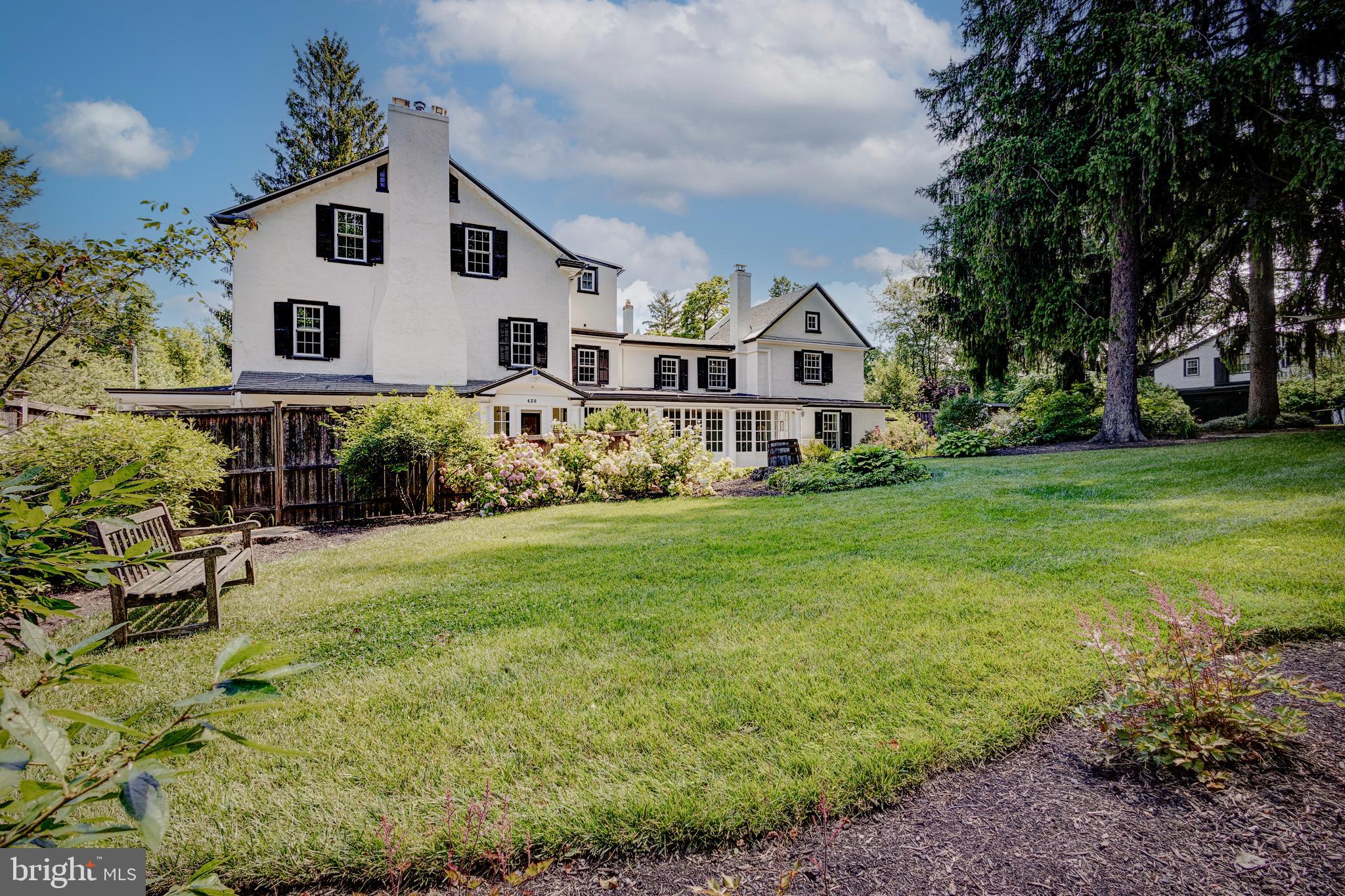 There’s space for everyone and a multitude of possibilities for exceptional living at ‘Wetherill House’; a one of a kind West Mount Airy historic oasis featuring a 5 bed, 3.5 bath home AND a 2 bed, 1 bath carriage house. In 1683, long before pioneering suburbanites moved to upper West Mount Airy to be near the wild and scenic Wissahickon, the Wetherill family arrived in Pennsylvania as Quakers to escape religious persecution in England. Just after the turn of the 19th century, the notable architect Herbert Johnson Wetherill, who was a Quaker, an abolitionist and a WWI veteran, settled his family at 420 West Allens Lane where multiple generations of Wetherill architects lived through 2001. Today this late 19th century home is full of fabulous historic detail, along with all the upgrades and amenities of modern living. Situated on nearly half an acre of immaculate grounds, the home and carriage house combination are ideal for multi-generational living, working from home, an artist in need of a studio, or a rental income opportunity. Imagine residing in the carriage house while transforming the main house into a charming bed and breakfast featuring three spacious sleeping suites. The opportunities are boundless! The main house welcomes you through a glass-paned vestibule into an elegant formal living room. This room features large windows, built-in bookshelves, original hardwood floors, and a magnificent fireplace that commands attention as its focal point. Adjacent to the living room is a spacious dining room, perfect for memorable gatherings. It is complemented by a butler’s pantry with wet bar, beverage refrigerator, granite countertops, and stylish built-in cabinets. The eat-in chef’s kitchen, equipped with stainless appliances, Smeg range and underfloor heating, is a light-filled, happy space with a convenient laundry area and powder room, while the rear-entry mudroom adds practicality. A sunlit family room with views across the lawn and a second fireplace completes the first level. The second floor, accessed by front and rear staircases, offers three bedrooms, including one currently configured as a suite with dressing room and en-suite bathroom and another with an adjacent sitting room and full bathroom. On the third floor, you'll discover a generous bedroom that could serve as the primary suite, alongside a versatile fifth bedroom that doubles as an office, dressing room, or sitting area. Lastly, there’s a beautiful bathroom with dual vanities, a soaking tub, and a separate walk-in shower. The historic carriage house, with its vaulted wood beam ceilings, wood-burning fireplace, and deck offering garden views, is the pièce de résistance! With two bedrooms, a galley kitchen, and a full bath, it provides an ideal space for guests, in-laws, a studio, tenants, or office. Below, there is a three-car garage with two EV chargers and abundant storage. Beautifully landscaped and fully fenced, the grounds offer both aesthetic beauty and practical space for gardening, playing, entertaining, and relaxation. Don’t forget to see the charming chicken coop! ! Freshly painted exterior; newer roofing; privacy fence; new chimney flues and EPA certified wood burning insert; and updated wiring and plumbing are all great advantages. The location offers easy access to the city, and the convenience of walking to dining, shopping, Fairmount Park trails and public transit in both Mount Airy and Chestnut Hill. This timeless home, full of historical charm and contemporary comforts, is absolutely one of a kind.