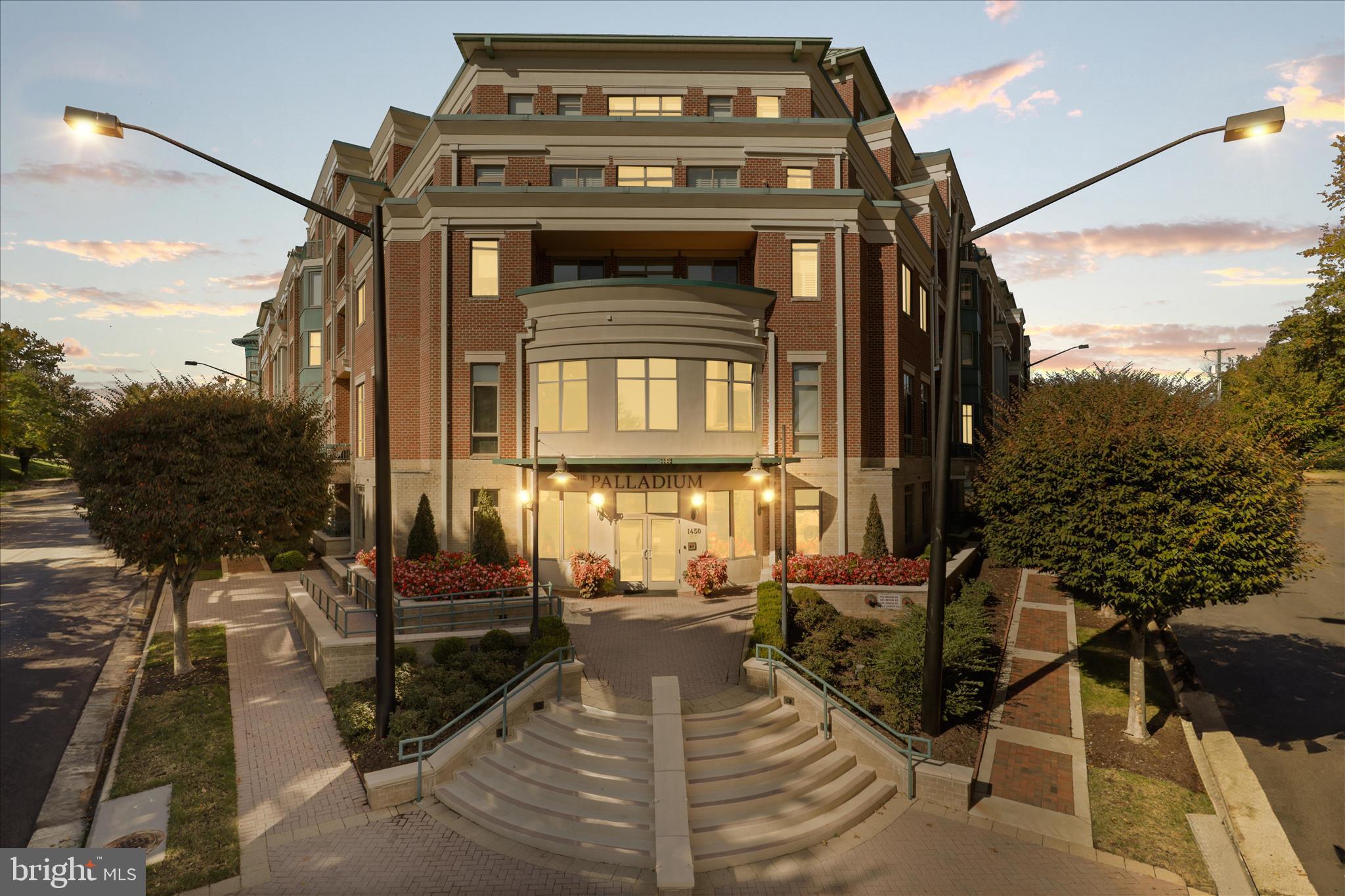 Enjoy an elevated, low-maintenance lifestyle in this beautifully reimagined residence within one of McLean’s most sought-after luxury condominium communities. Thoughtfully designed for those who value both space and simplicity, this expansive two-bedroom, two-and-a-half-bath home with a den offers refined comfort, privacy, and timeless sophistication.
From the moment you enter, rich walnut-toned flooring and soaring 10-foot ceilings set the tone—filling the home with warmth, light, and understated elegance. Every detail has been carefully curated, blending classic design with modern functionality to create a residence that feels both elevated and inviting.
The kitchen is as practical as it is polished, featuring rich wood cabinetry, granite countertops, and a generous breakfast bar ideal for casual dining or entertaining. A premium Viking gas range with external ventilation anchors the space, complemented by a suite of integrated KitchenAid appliances, including a counter-depth refrigerator, dishwasher, and microwave delivering a seamless, high-end aesthetic.
A thoughtfully designed split floorplan provides exceptional privacy, with bedroom suites positioned on opposite sides of the home. The primary suite serves as a true retreat, complete with a sitting area, two custom-organized closets, and a spa-inspired bath featuring a double vanity, soaking tub, and walk-in shower with bench seating. The secondary bedroom overlooks the private covered patio and includes its own well-appointed bath, perfect for guests or extended stays.
Recent upgrades, including a new HVAC system and hot water heater (2023), offer peace of mind and effortless living.
Additional highlights include two garage parking spaces, a large private storage room, and a private outdoor patio—along with exceptional walkability to the shops, dining, and everyday conveniences that define life in McLean.
Residents of The Palladium enjoy a well-managed, highly regarded building with concierge service, a fitness center, party room, library, and beautifully maintained common spaces, including an inviting courtyard designed for relaxation and connection.
This is a rare opportunity to enjoy a lock-and-leave lifestyle without compromising on space, comfort, or sophistication.