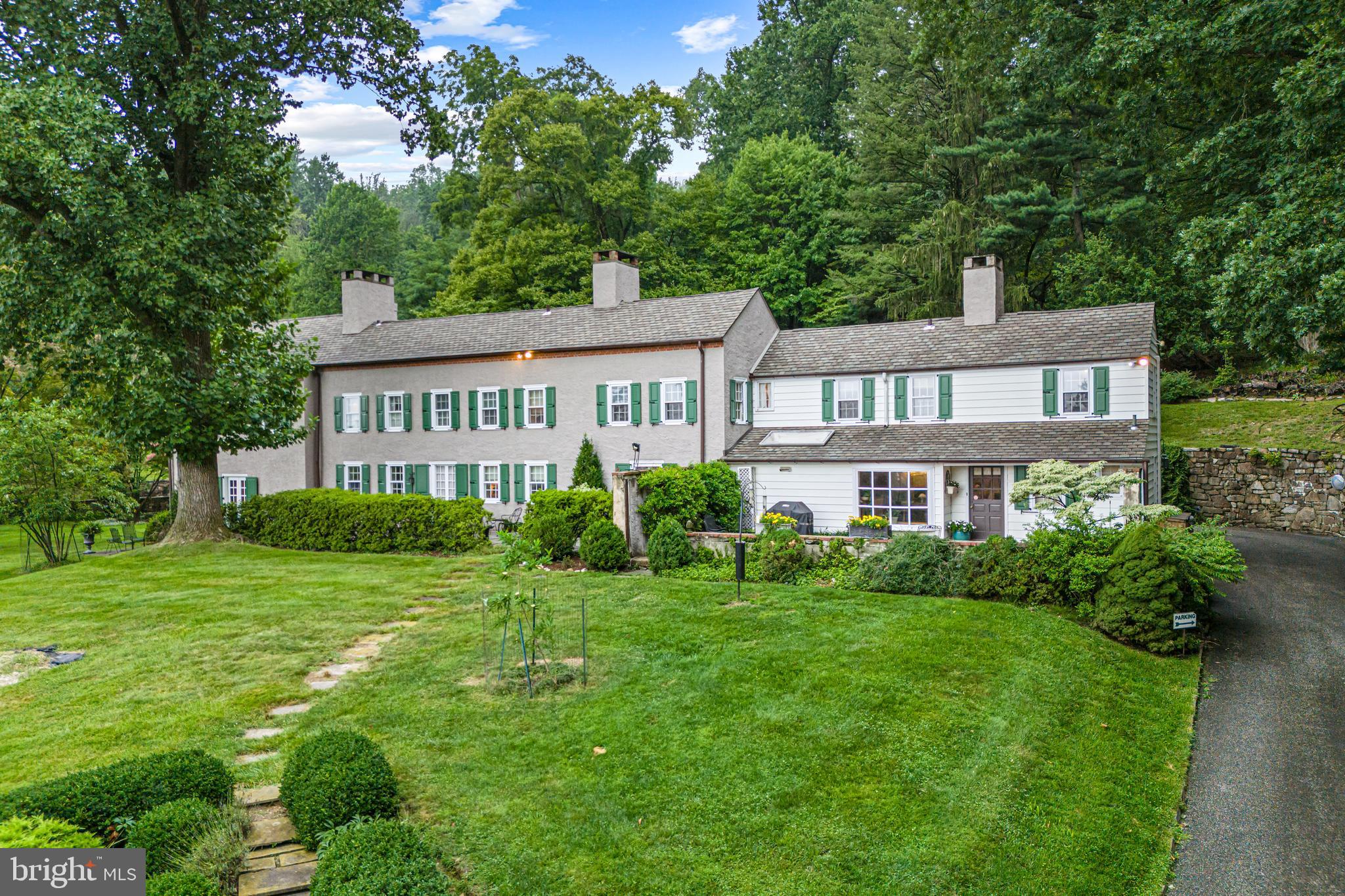 Diamond Rock Farm sits majestically at the base of Valley Forge Mountain. This stunning home was built over three centuries starting in the 1760’s with updates and expansions in the 1850s and 1930’s. This home exudes a true sense of timeless elegance with its four fireplaces, slate and hardwood floors and original millwork and hardware. A home and property of this size and caliber in the T/E school district is an extremely rare find. 
As you step inside, you'll be transported back in time to an era of sophistication. The home has been lovingly restored and updated, with modern amenities seamlessly integrated into the historic architecture.
The main level includes the cozy original 1700’s hearth room opening up to a grand 1920’s parlor style living room (newly updated in 2019) with solid hardwood wainscot panels from floor to ceiling, The fireplace is the undeniable focal point- complete with the original upholstered brass fender. There are French doors leading from this room outside to the bluestone slate terrace.
The big, bright eat-in kitchen was updated in 2016 with fresh paint, neutral flooring and backsplash, new Caesarstone countertops, granite window sills and stainless steel appliances. It holds the potential for a chef's dream, with plenty of prep space and an oversized island. Through the kitchen you will find the beautifully appointed formal dining room and library/gathering room with built in bookcases and fireplace. Each room has a set of French doors to the terrace outside.

Upstairs, the bright and airy primary suite (Fully updated in 2019) is ideally appointed with his and hers bathrooms and original built-in cabinetry. There is an adjoining dressing room with a wall of built in floor to ceiling cabinets which would also be perfect as a nursery. There are two additional ensuite bedrooms on the second floor, as well as the surprise of a 1970s retro kitchen that could be easily converted to an additional bedroom and bath or home office with a wet bar! There is also a large room open to the hall, currently an office, which would be perfect as a homework/hangout area for kids. There is also a laundry chute for easy delivery of clothing and linens to the laundry room just off of the kitchen.
Climbing the wide staircase to the third floor, the bedroom includes an adjacent sitting room and private bath, perfect for an au pair suite.
*The main house also features a whole house generator.

Outside, the grounds are alive with vibrant flower beds and a lush lawn as well as a fenced in garden beside the barn. There is a multi-level terrace that runs the length of the main house, perfect for al fresco dining, bird watching or just relaxing with friends or family.  The beautifully landscaped gardens offer a sense of tranquility and peace.
Above the house up stone steps and into a wooded area of the property lies a pool that has not been used for 20 years. Let your imagination be your guide as you reinvent this potential oasis! There are also a number of outbuildings including a large barn with a three car garage underneath. As the barn is already partially finished, there is the potential for creating a full ‘Party Barn’ in which to entertain.  A quaint potting shed and once lively playhouse provide additional recreation space as well as plenty of storage for all of your treasures. The lucky new owner will be confined only by their imagination!

The home sits on 10 acres of wooded grounds which allows for significantly reduced taxes as it is designated a Farm. It is in a Rural Conservation zone. 

Located minutes from Valley Forge National Park with 3,500 acres of land with walking /biking trails as well as a 300 acre land conservancy less than a mile away on N. Valley Rd.  This is a rare opportunity to possess your own piece of history in one of Pennsylvania's most highly regarded areas and the award-winning T/E school district.
Only minutes from Route 202 and the PA turnpike as well as SEPTA railways.