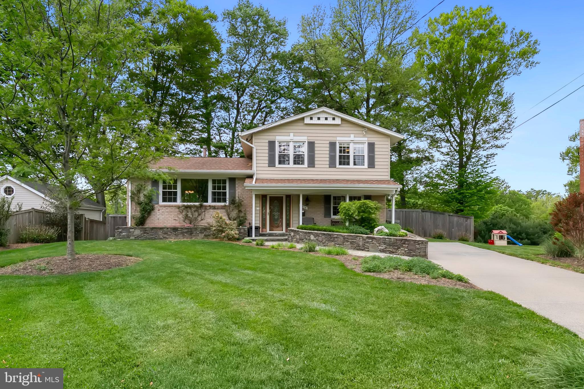 Welcome to this beautifully updated 4-bedroom, 2.5-bath split-level home, where thoughtful upgrades and classic charm come together to create a warm, inviting living experience. Set behind a covered flagstone porch and manicured stone garden walls, with private driveway, the home's curb appeal sets the tone for what awaits inside. Step into a bright and welcoming foyer with a stone floor, sidelighted front door, and a coat closet with custom shelving. The main level features a sunlit living room with gleaming hardwood floors, crown molding, built-in speakers, recessed lighting, and a wall-mounted flat-screen TV that conveys. Adjacent, the formal dining room exudes sophistication with more hardwood flooring, elegant crown, chair rail, and panel moldings—perfect for hosting special gatherings. The updated kitchen boasts granite countertops, ceramic tile flooring, newer cabinetry, and sleek stainless steel appliances, offering both beauty and function. A versatile main-level bedroom can also serve as a home office, complete with Berber carpet, molding details, and a ceiling fan. The stylish powder room wows with a natural rock accent wall, stone flooring, and a granite-topped bowl sink vanity. The inviting family room showcases Brazilian tigerwood floors, detailed crown molding, recessed lighting, and a custom built-in butcher block counter. A granite-topped butler’s pantry with stainless wine fridge and glass shelving adds convenience for entertaining. with door that leads to an expansive stone-tile patio in a fully fenced backyard oasis, featuring a built-in natural gas grill with fridge and trash storage, a powered shed, and dual side gates—perfect for outdoor living. The finished basement offers a large recreation room with Berber carpet, built-in speakers and wiring, recessed lights, and a second flat-screen TV that conveys. There's also a functional workshop, laundry area with LG washer and gas dryer, utility sink, extra fridge, and ceramic tile flooring. Upstairs, the primary suite is a serene retreat with hardwood floors, dual closets with custom shelving, recessed lighting, and crown and base molding. Its ensuite bath includes ceramic tile floors, a pedestal sink, window, and walk-in shower. Three additional bedrooms offer hardwood floors, ceiling fans, attic access, and beautiful trim details. A renovated hall bath features a marble and ceramic tile floor, designer inlays, a tub/shower combo, and a luxurious marble vanity. With the roof, windows and HVAC systems having been replaced over the years, and so many custom enhancements, this home is truly move-in ready. It’s a rare blend of craftsmanship, space, and style. Located in the heart of Rockville, Maryland, 5214 Drake Terrace offers residents a blend of suburban tranquility and urban convenience. The home is just minutes from Rock Creek Park, providing access to scenic trails and outdoor recreation. Nearby, Rockville Town Center features a variety of shopping, dining, and entertainment options. For commuters, the Twinbrook and Rockville Metro Stations and major routes like I-270 and MD-355 are easily accessible, ensuring smooth travel throughout the region. Families will appreciate the proximity to top-rated Montgomery County schools and local parks, making this location ideal for both relaxation and connectivity.​ Schedule your private showing today!