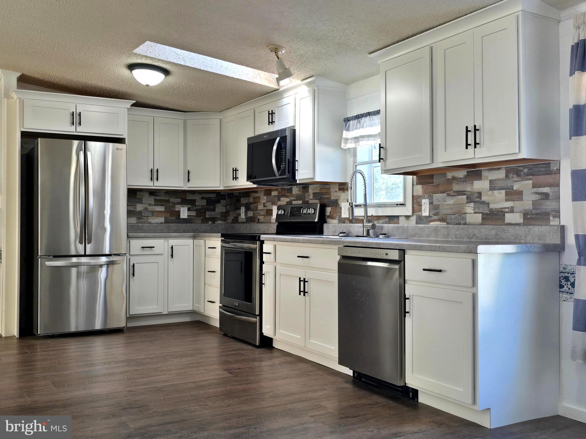 Welcome to this spacious three bedroom, two full bath home. Fresh paint, new flooring, new kitchen cabinets, and master bathroom.
  This home has an exceptionally large open floor plan with a spacious living room as well as a large family room. Enjoy cooking with brand new kitchen cabinets featuring a built-in dishwasher and microwave. The kitchen is connected to the dining room area and is open to both the family and living room. 
The private master bedroom  is 12.5 feet wide x 13 feet wide with a walk-in closet and  a large master bath with a new double vanity, deep luxury soaker tub, and a separate shower for your convenience.
The living room leads out to a 7 foot x 22 foot long deck that is shaded from the afternoon sun.

The lot fee is $670 (610. plus 60 sewer cost) The lot rent includes water, sewer, and trash service.