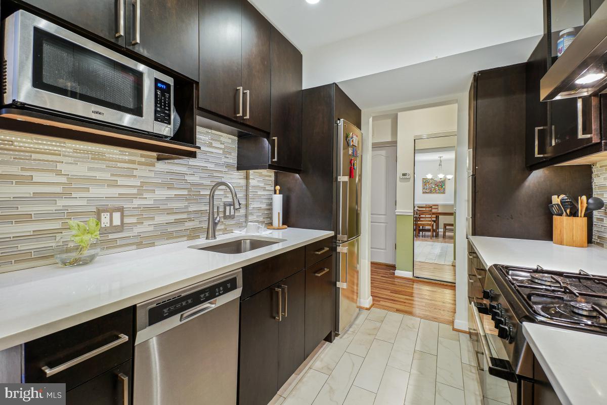 Enjoy the perfect downtown Bethesda location in your beautifully upgraded and bright 1 bedroom in a pet friendly building with all inclusive condo fees. And check out the 5K down-payment assistance loan program available on this property - income restrictions apply! This spacious and inviting condo is move in ready for the most discerning buyers. Warm oak-look flooring in the living area, with floor to ceiling windows bathing the unit in sunlight. The upgraded kitchen features modern dark cabinetry some with glass fronts, a chic glass backsplash, stone counters, stainless steel appliances  and desirable gas cooking  The kitchen opens to the lovely dining area.  The living room/dining room is complemented by a chair rail with contrasting paint color below. The spacious bedroom has carpet for a cozy feel, and comes with a roomy walk in closet . The updated bathroom is accessible from the foyer as well as the bedroom.
The condo fee includes all utilities, plus maintenance/repair/replacement of the HVAC system. A large storage unit (in Storage Room 4) takes care of all the extras you need to keep at hand. The building delivers a fitness center, secure bicycle storage room, and a "party room" with refrigerator. Adjacent to Battery Lane Urban Park with tennis courts. Harris Teeter and many restaurants are a few blocks away, along with NIH, Suburban Hospital, bus lines and Red Line Metro. Easy to show and ready for you -- as well as a pet! Up to 2 dogs (under 50 lbs each) allowed, with $10/monthly fee per dog.
