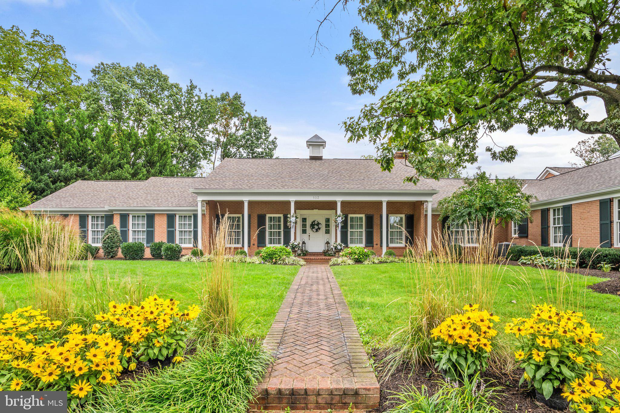This luxury ranch estate boasts a whopping 8,295 square feet (with another 1,152 in the basement) on a lovely 1.5 acres.  In 1998 the home was completely remodeled and expanded by the local, renowned architectural firm of Reader and Swartz. This home features beautiful, all-brick craftsmanship with herringbone details and hardscaping, curated landscaping, and mature trees for additional privacy. Inside, each room is stately, with fine details such as dentil molding, chair railing, hardwood floors, pleasing paint choices, and several fireplaces. The windows are also plentiful, especially along the rear-facing side of the home, allowing for big doses of natural light. With all that square footage, you’ll be delighted by the many locations to relax, retreat, or gather. The first is a formal living room, big enough for sofas and a piano while still feeling inviting and cozy. In the formal dining room, easily seat a dozen or more, plus add in display cases and buffet pieces. A large fireplace gives this space added warmth. You won’t believe the gourmet kitchen—a true chef’s dream where high-quality wood cabinets surround not just one, but two sizeable islands. One houses a commercial-grade gas range plus an electric range, and you’ll find additional refrigerator and freezer appliances conveniently in-island too. Featuring two commercial grade ovens (one electric and one gas), plus a warming drawer. On one end, an adjacent informal dining sits beside yet another Rumford fireplace. On the other end, segue directly into the spacious family room, where you can arrange dining and comfortable furniture in the layout of your choice, all anchored by a massive fireplace. On this floor, there are a total of four bedrooms—all with attached baths and walk-in closets. The primary suite gives you the kind of space you’ve longed for, holding essential furniture and extras, plus more in the adjacent sitting room. This home redefines “walk in closet” by giving you a “walk in room.” A bathroom of a similar size houses a long double vanity, private commode area, shower, and whirlpool tub (with a TV if you want to catch up on shows while you soak). The laundry room is a marvel with two washers and dryers, banks of cabinets, and counters for folding. A half bath rounds out the main level. Upstairs is a bonus bedroom and full bath plus unfinished attic storage. Head downstairs to enjoy more prime living, recreating, and gathering space. It’s carpeted and contains another fireplace and half bath. You won’t be left wanting for places to relax or gather in the backyard oasis—there’s plenty. An undercover patio with a tabletop fire pit faces the rectangular swimming pool (with a slide and diving board) and backs to a formidable brick fireplace. On the other end of the pool is an outdoor patio with plenty of seating and umbrellas that can be used for shade or left closed to sunbathe plus a raised deck perfect for dining al fresco. The beautifully bricked hardscape opens to the lawn and is fully fenced. A pool house stores your pool items easily, and on the other side of the lawn, a larger building stores garden and maintenance tools and equipment. The home includes two attached garages featuring two bays each. And with its location right by the Winchester Country Club, it’s only minutes from downtown. This is truly a unique property and opportunity—one you’ll want to view in person!