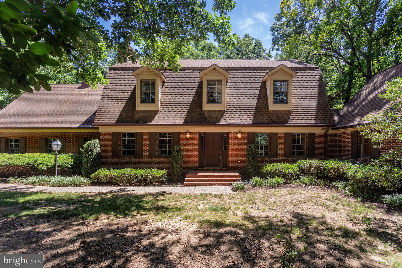 48 wooded acres put real distance between this home and the outside world! At the end of a long paved driveway, a spacious brick home sits in the middle, with privacy on every side. The main level has multiple living areas: A completely open kitchen, dining, and living area with rich cherry cabinetry and a wood-burning fireplace. A great room with a Vermont wood-stove that opens to a sun room with three skylights and a hot tub. An owner's suite that is practically an entire wing, including a private sun room, enormous bedroom with cathedral ceiling, walk-in closet, full bath with separate vanities, and home office/bonus room. Also on the main level: laundry room with built-in cabinetry, half bath, and double garage. Upstairs are three more bedrooms, two full baths, and a large rec room room over the garage. Gorgeous pine flooring in many areas of this home!