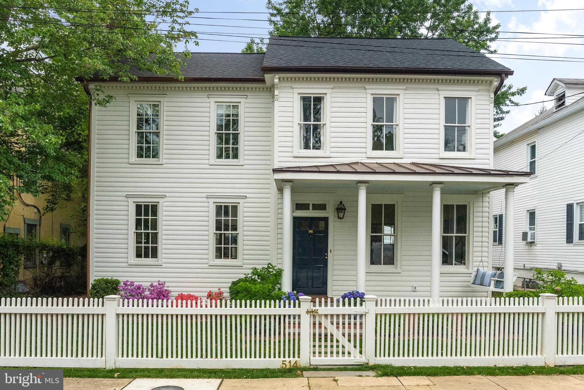 Nantucket meets Martha's Vineyard in this exemplary renovation, completed in 2017. A cut above the standard Eastport homes. This home was re-built with high quality finishes and attention to detail. Entering the home, you are greeted by a gas-lit copper lantern. A wooden swing hangs at the edge of the front porch inviting you to sit and enjoy the peaceful setting. High-end paints and wall coverings are throughout the home. The German Lap siding was custom milled to replicate the original 1920 s profile. Wide-plank white-oak hardwood flooring with a subtle white-wash creates an elegant coastal feel. Tall ceilings over 9  feature beautiful crowned white molding. Full masonry fireplace and chimney. Honed white Carrara marble kitchen with shiplap decor. Full suite of Subzero appliances with 2 dishwashers and 6-burner, dual fuel Wolf Range. Kitchen pantry with storage, coffee bar and beverage center. Generous window light in this home, with kitchen views of the large rear yard and carriage house. Carriage house includes renovated, 2-car garage. Brick patio and brick path leads to an all-cedar fence and a white stone driveway which can hold up to 5 cars in addition to the garage bays. The carriage house features a home office over the garage, balcony for entertaining, kitchenette, family room and full bath. Second floor of main home offers four bedrooms with 3 full baths, plus a third floor play area or home office and attic storage. All bathrooms feature marble tile and vanity tops. Charming details abound, including barn-doors, a hidden storage cabinet and a hidden step stool in the Jack & Jill bath. If you are seeking quality beyond the ordinary with easy access to restaurants, shops, yacht clubs, marinas and more, this home will impress you.