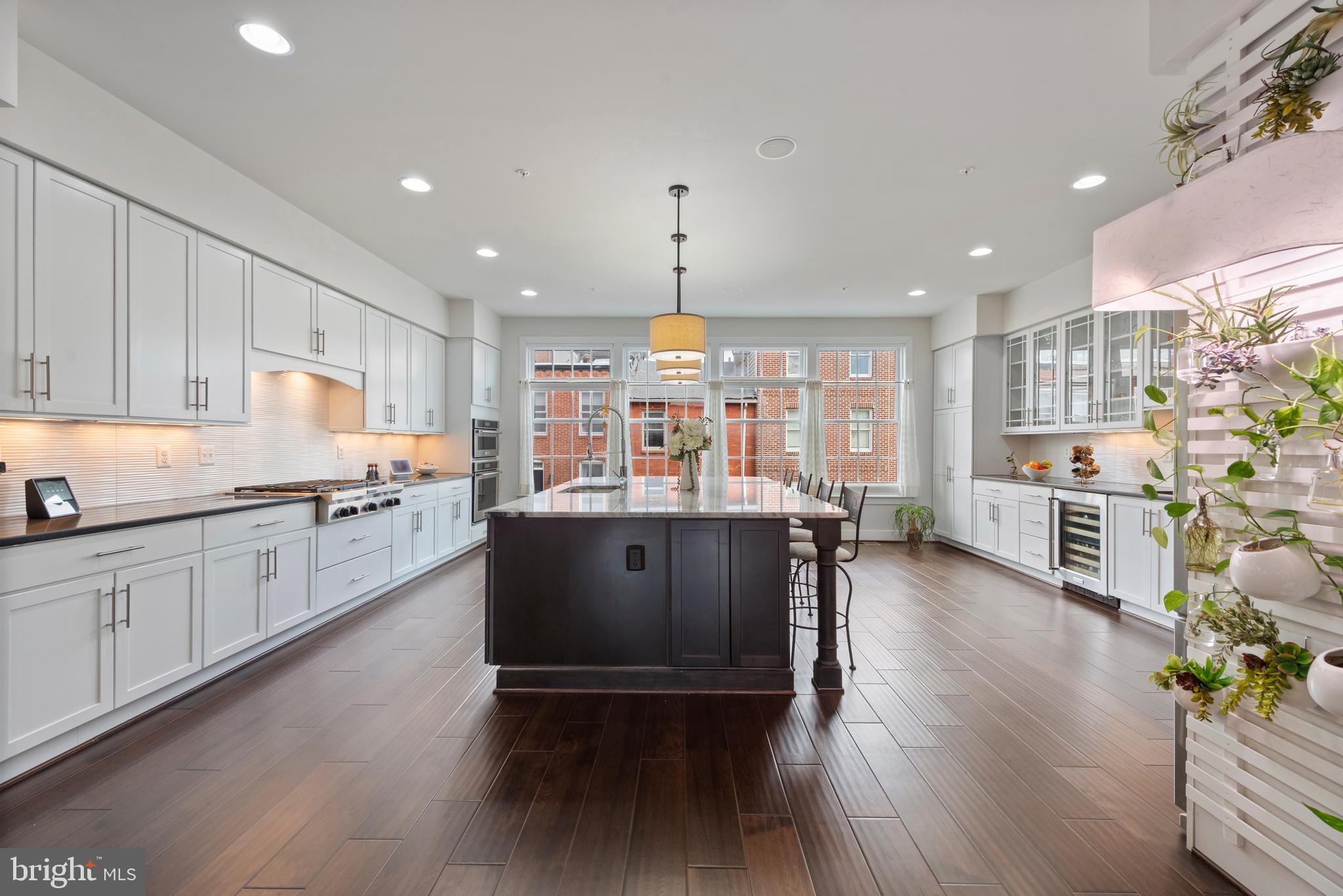 Located in the heart of vibrant Canton, this exceptional 24-foot-wide luxury residence offers more than 4,000 square feet of thoughtfully designed space. Expansive interiors, abundant natural light, and refined finishes create an inviting atmosphere throughout, while a private in-home elevator provides seamless access to every level. At the center of the home is a stunning chef’s kitchen designed for both everyday living and effortless entertaining, featuring premium appliances, generous workspace, and elegant cabinetry. The property also offers remarkable flexibility, including a fully finished lower level with heated floors and kitchen hookups already in place—perfect for creating a private in-law or guest suite ideal for extended family, visitors, or additional living space. Practical luxury continues with a rare attached two-car garage that provides both convenience and security, along with a dedicated dog bath—perfect for rinsing off pets after a walk along the waterfront or a day at the park. Above it all, a full-footprint rooftop deck showcases sweeping city views, offering a spectacular setting to take in both sunrise and sunset over the Baltimore skyline. Combining generous scale, refined finishes, and an exceptional location near the waterfront, dining, and shops, this distinctive residence represents luxury city living at its finest in one of Baltimore’s most sought-after neighborhoods. Seller is providing a Home Warranty! Be sure to watch the video for a home tour!