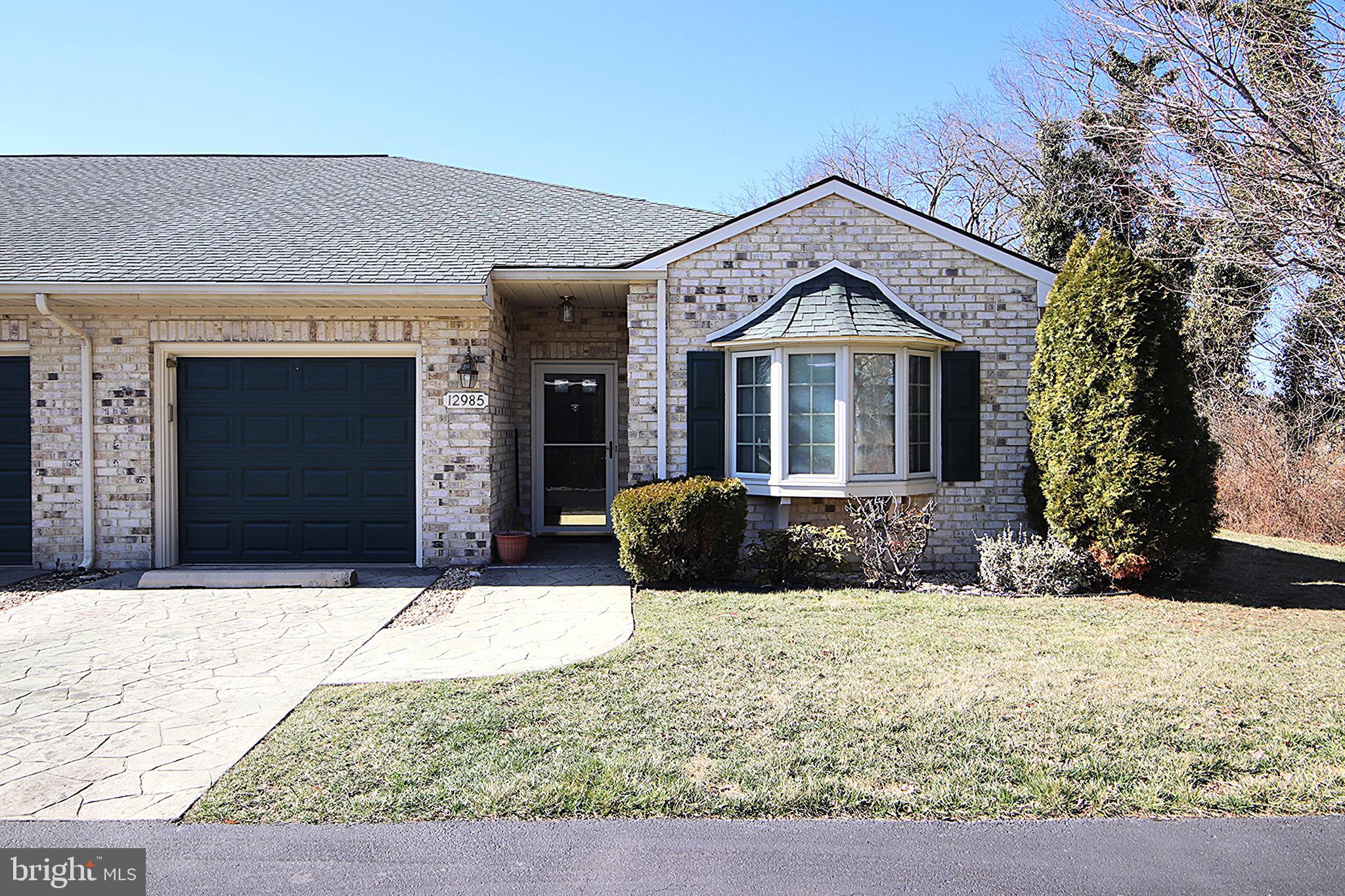 One level living at its finest in this lovely end-unit townhouse with farm views!  This unit features 2 Bedrooms and 2 full Bathrooms, Kitchen with island that is open to Dining Area, large Living Room, sunroom, patio, and a one-car garage.  Freshly painted, laminate & vinyl floors throughout, and new hot water heater.  Convenient location close to shopping and restaurants.