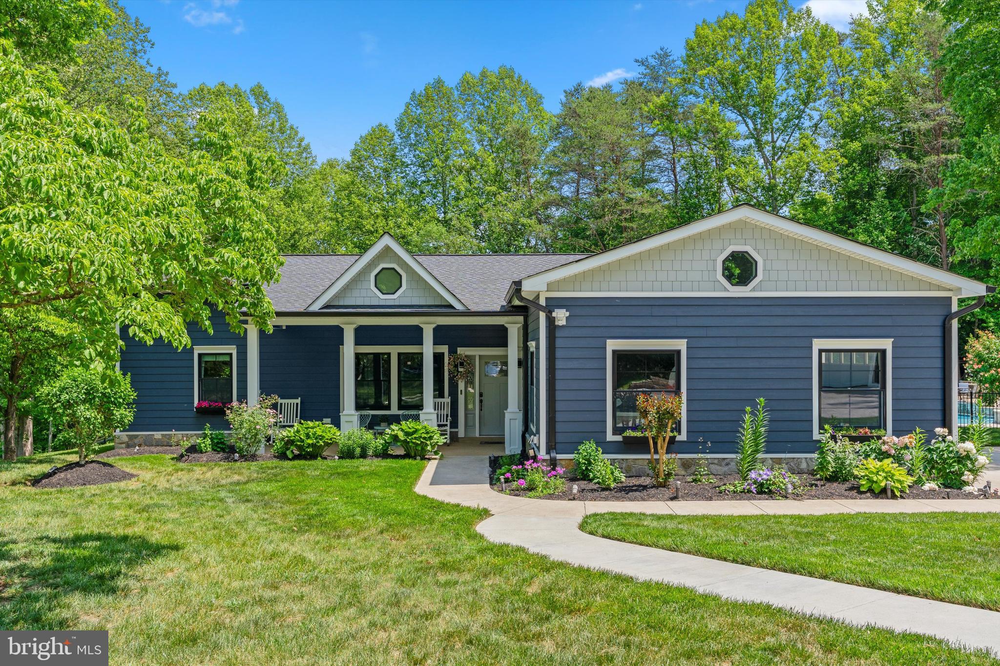 Welcome home to this ranch/rambler-style retreat that has undergone a major renovation and expansion, nestled on 2.5 peaceful acres with beautifully maintained landscaping that adds charm, privacy, and incredible curb appeal. Updated just 4 years ago, this exceptional property offers 5 spacious bedrooms, 4 full baths, and 3,170 sqft of warm, inviting living space designed for both everyday comfort and unforgettable entertaining. The gourmet kitchen is the heart of the home, featuring elegant quartz countertops, custom cabinet lighting, and premium finishes throughout. Soaring high ceilings and skylights fill the open-concept layout with an abundance of natural light, creating a bright and welcoming atmosphere in every room. Cozy evenings are made even better with a stylish electric fireplace that adds warmth and ambiance to the living space.

Step outside and enjoy your own private backyard paradise complete with a resort-style pool ranging from 3–8 feet deep, relaxing hot tubs, a beautiful waterfall feature, and vibrant color-changing lights perfect for evening gatherings under the stars. The outdoor entertaining area also features a charming brick wood stove, ideal for summer barbecues and hosting family and friends. Car enthusiasts and guests will appreciate the spacious 3-car garage setup, including 2 attached garage spaces and 1 detached garage for added flexibility and storage. Conveniently located near the beautiful Occoquan River and Bull Run Marina Regional Park, this home offers easy access to outdoor recreation, boating, trails, and scenic nature views. Combining modern luxury with the charm of country-style living, this turnkey home offers the perfect blend of space, comfort, and tranquility.