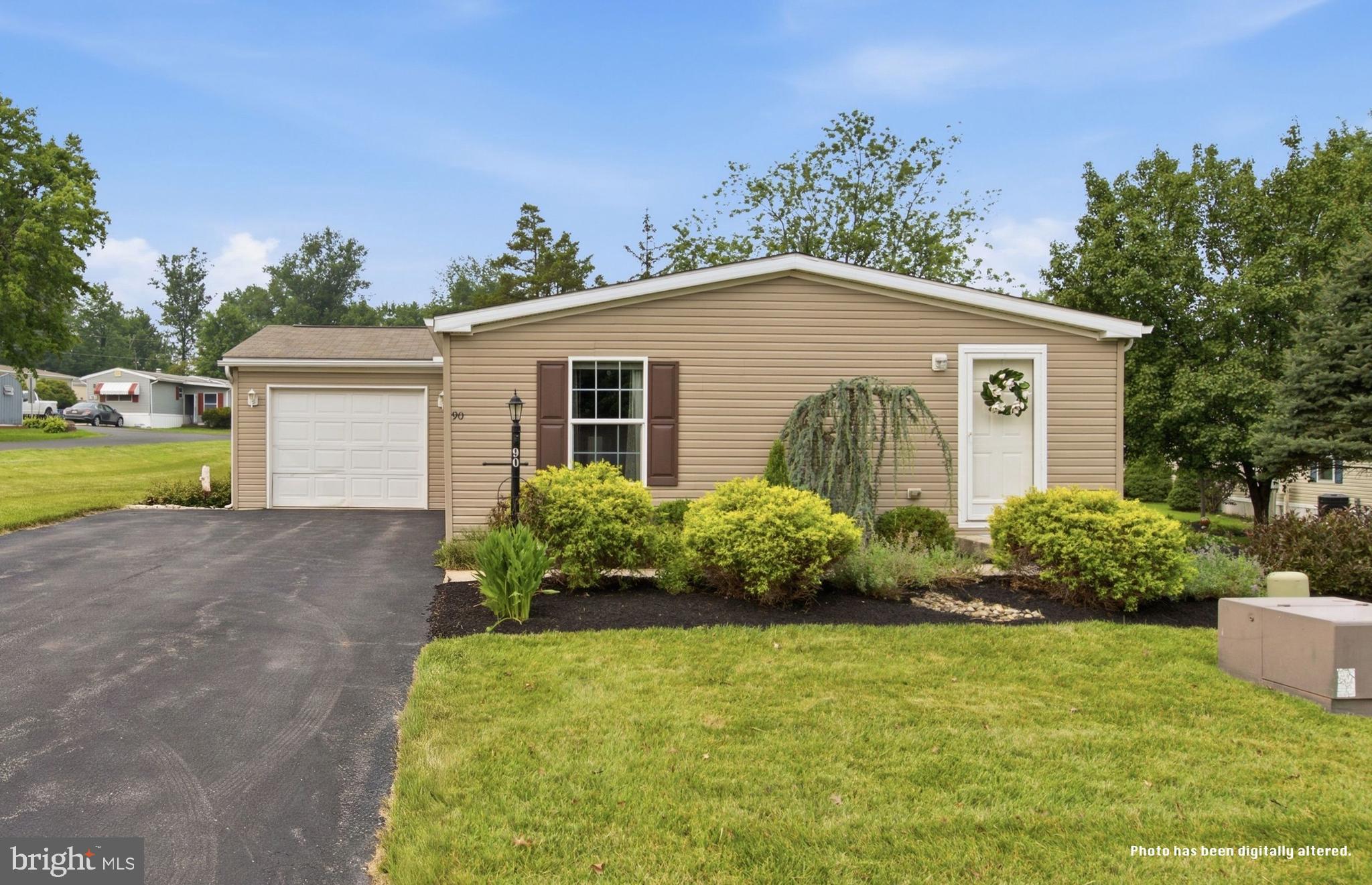 Welcome to 90 Robin Lane, located in the highly sought-after Quiet Acres Community, a 55+ community in Sellersville. This beautifully maintained home is one of the newer homes in the community, built in 2017, and offers convenient one-story living. Situated on a desirable corner lot with a spacious backyard, the property features a driveway that accommodates up to four vehicles, plus an attached one-car garage. From the moment you arrive, you'll appreciate the exceptional curb appeal, highlighted by beautifully landscaped, freshly mulched flower beds that wrap around the home. Step inside to discover a spacious living room that flows seamlessly into the dining area. Just off the dining room is the well-appointed kitchen, which leads to a convenient utility room with a washer and dryer. The home offers two bedrooms and two full bathrooms. The primary suite features a walk-in closet and a private en-suite bathroom. The second bedroom also has its own private entrance, making it ideal for guests or a home office. This home is truly move-in ready and can even be sold fully furnished if the buyer desires. Residents of Quiet Acres also enjoy access to the community clubhouse, which hosts scheduled events and social gatherings throughout the year.